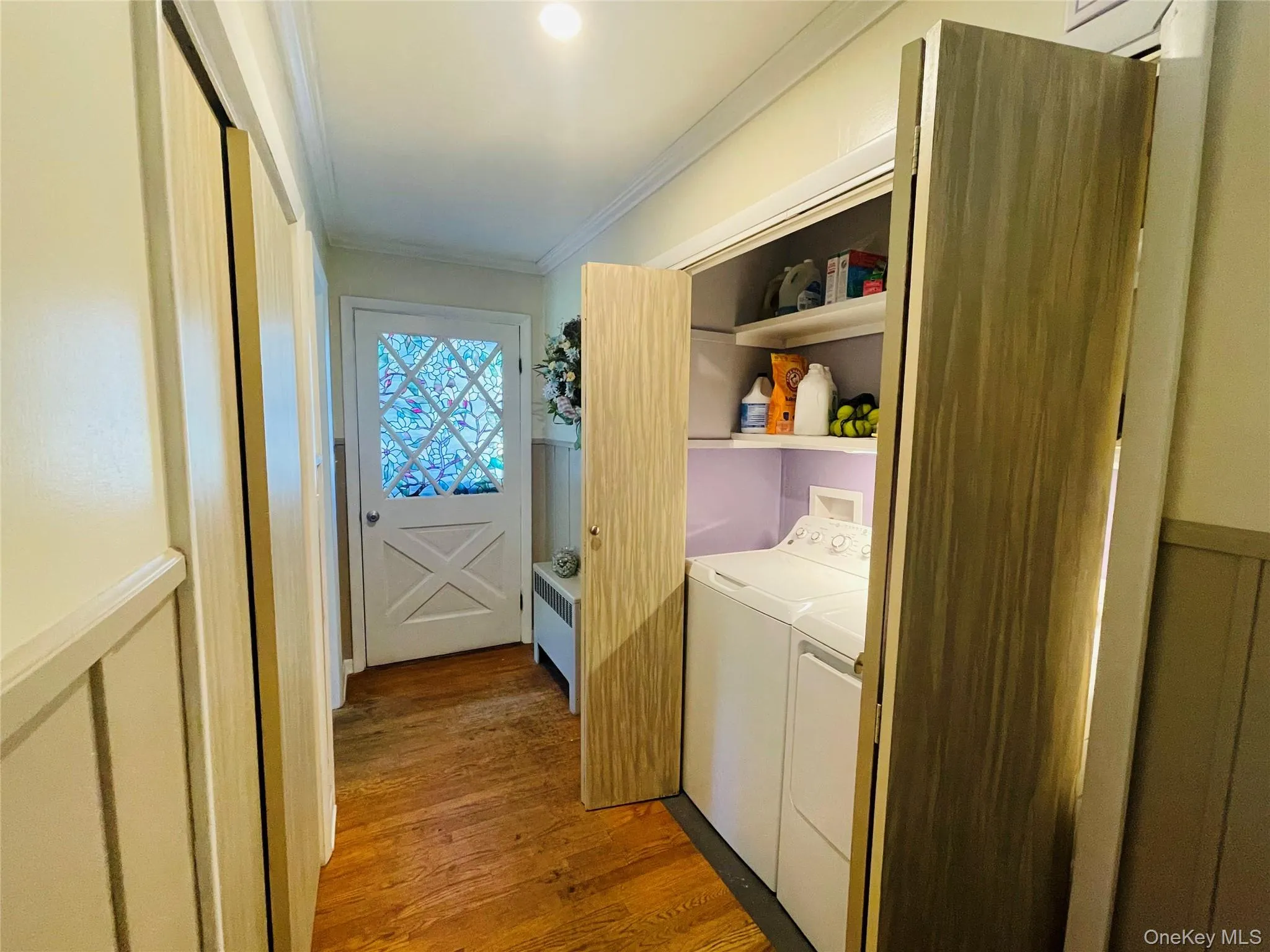 Hallway view of washer/dryer laundry area and egress. Hallway view of washer/dryer laundry area and egress.