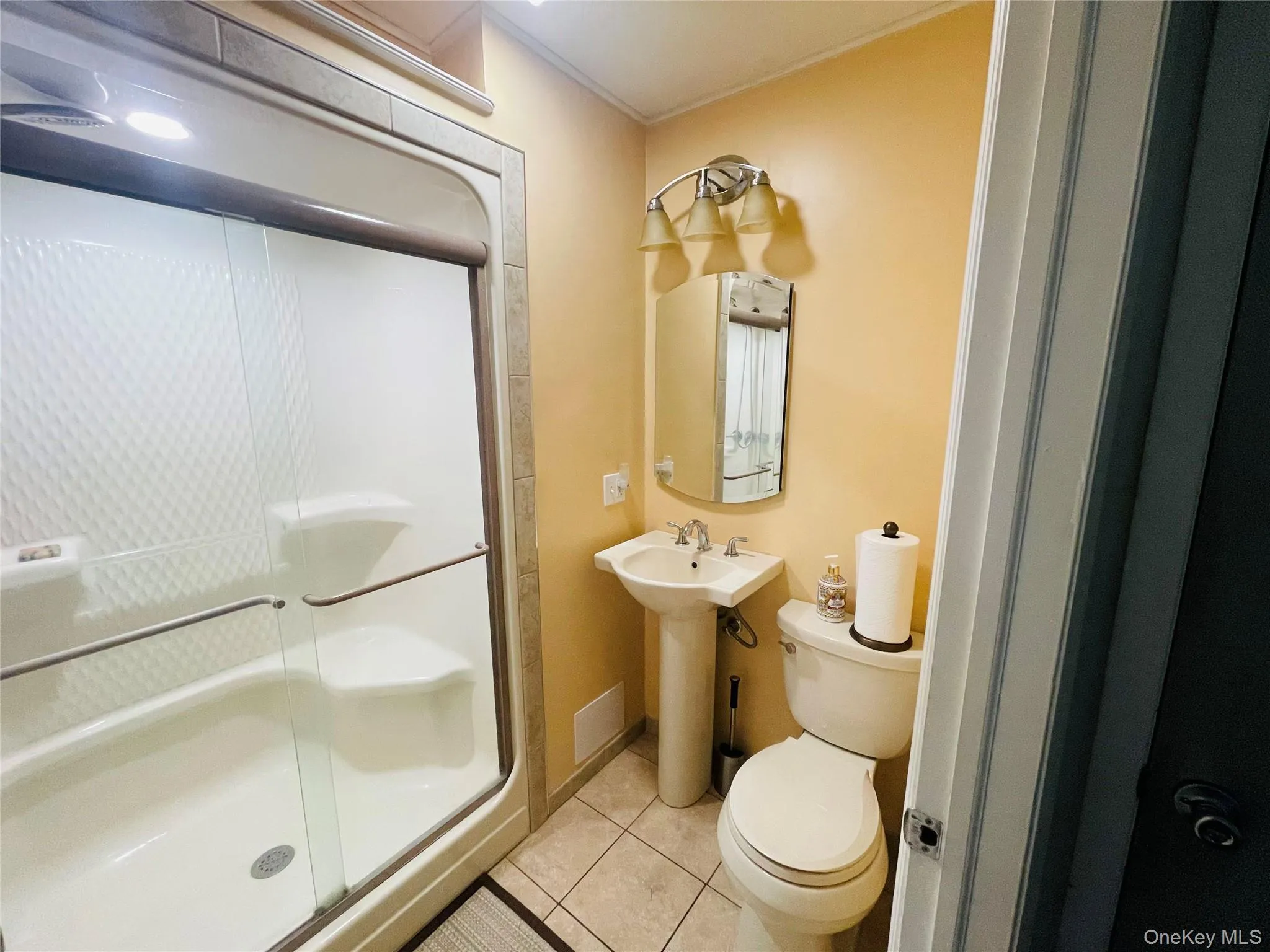 Bathroom with shower located off the kitchen. Bathroom with shower located off the kitchen.