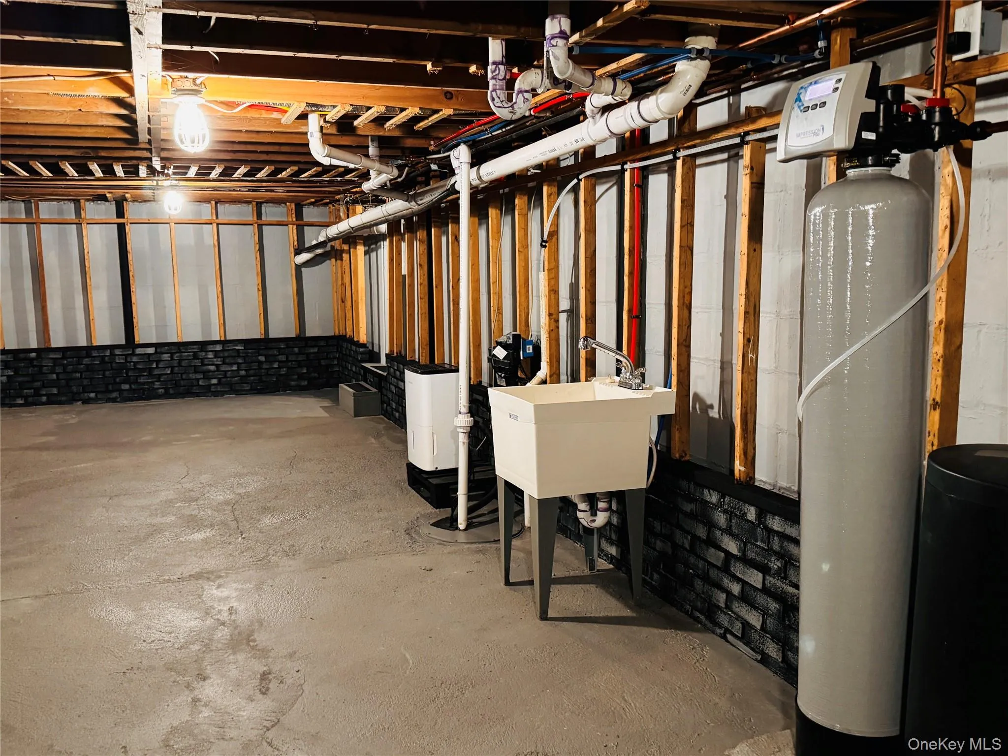 Basement with concrete flooring and sinks. Basement with concrete flooring and sinks.