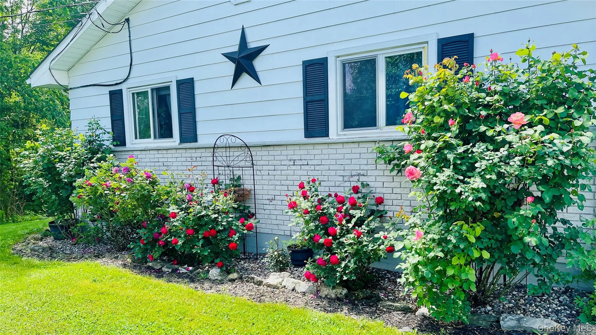 Enjoy the Rose gardens on side of home in front yard. Enjoy the Rose gardens on side of home in front yard.