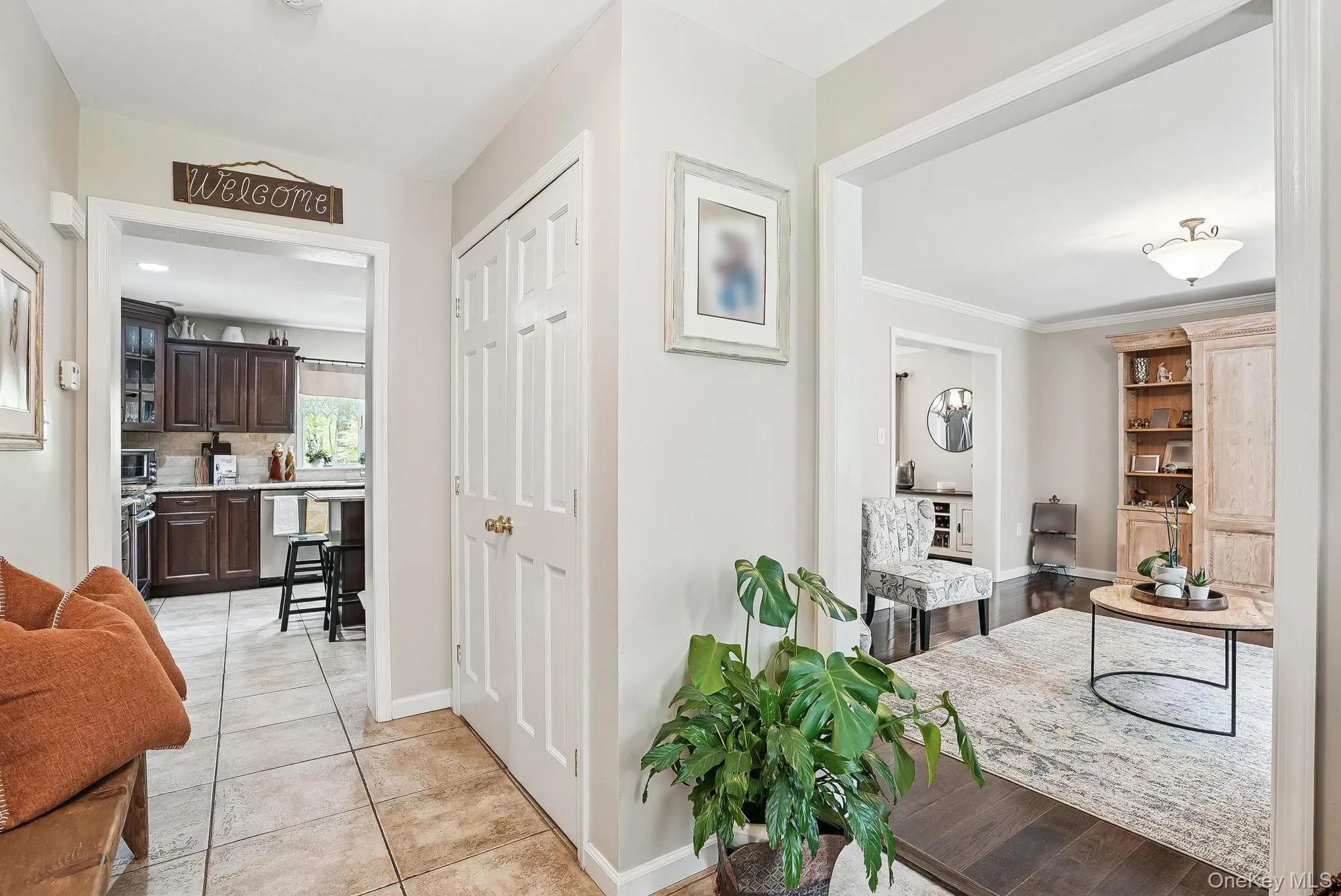 Hallway with baseboards and light tile patterned floors Hallway with baseboards and light tile patterned floors