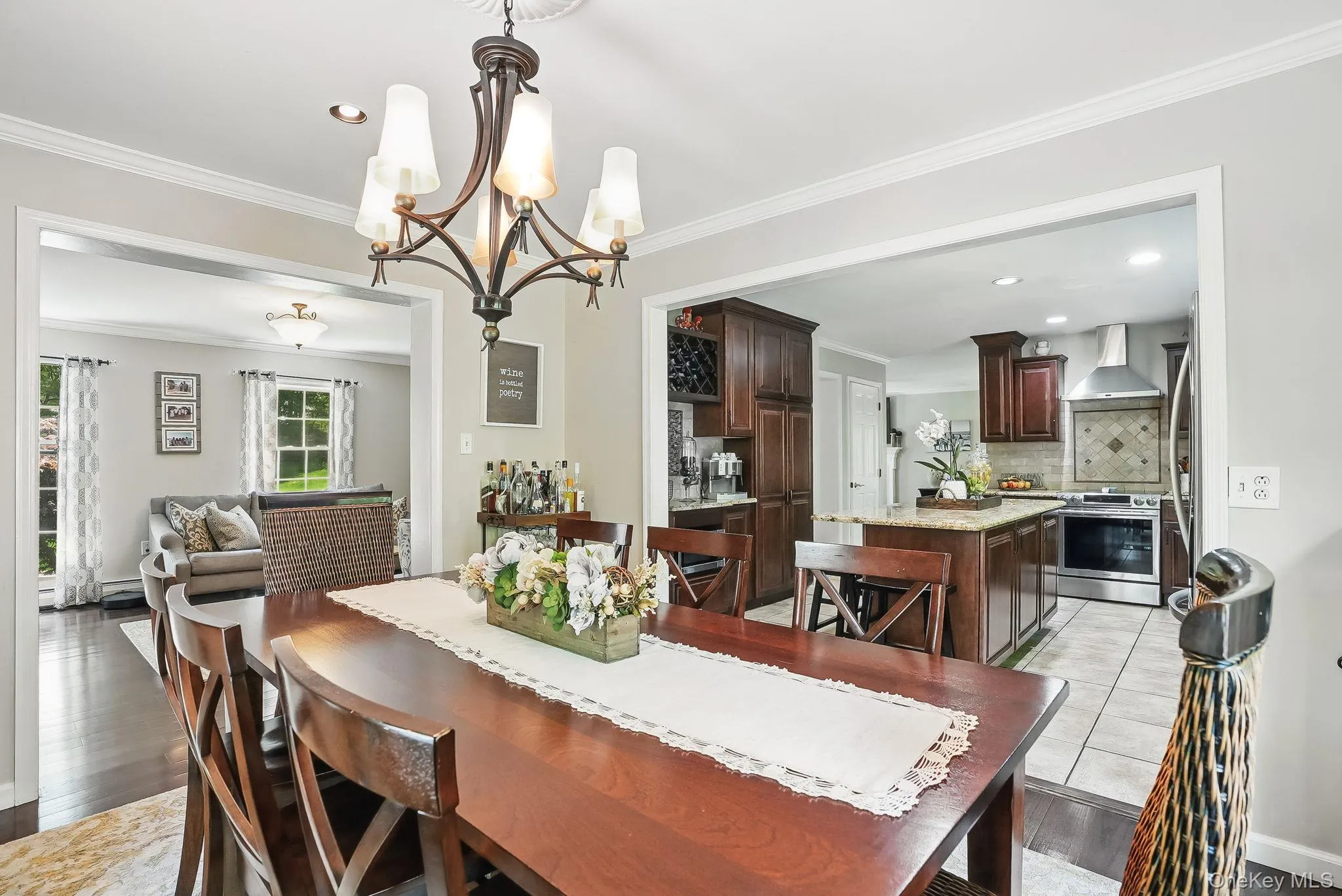 Dining space featuring a chandelier, crown molding, light wood-style floors, and recessed lighting Dining space featuring a chandelier, crown molding, light wood-style floors, and recessed lighting