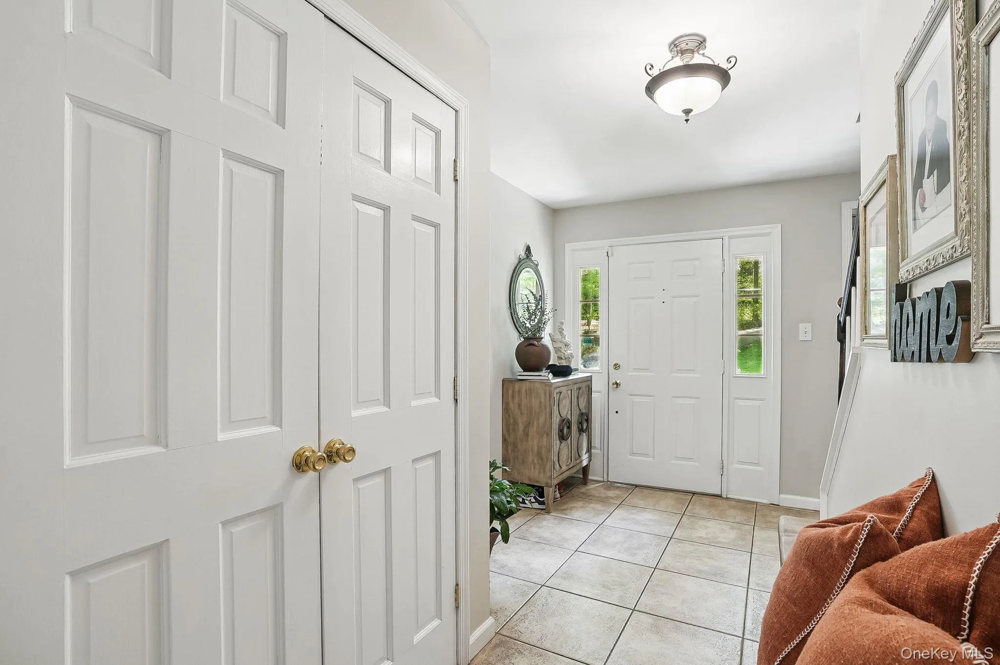 Foyer featuring light tile patterned flooring and baseboards Foyer featuring light tile patterned flooring and baseboards