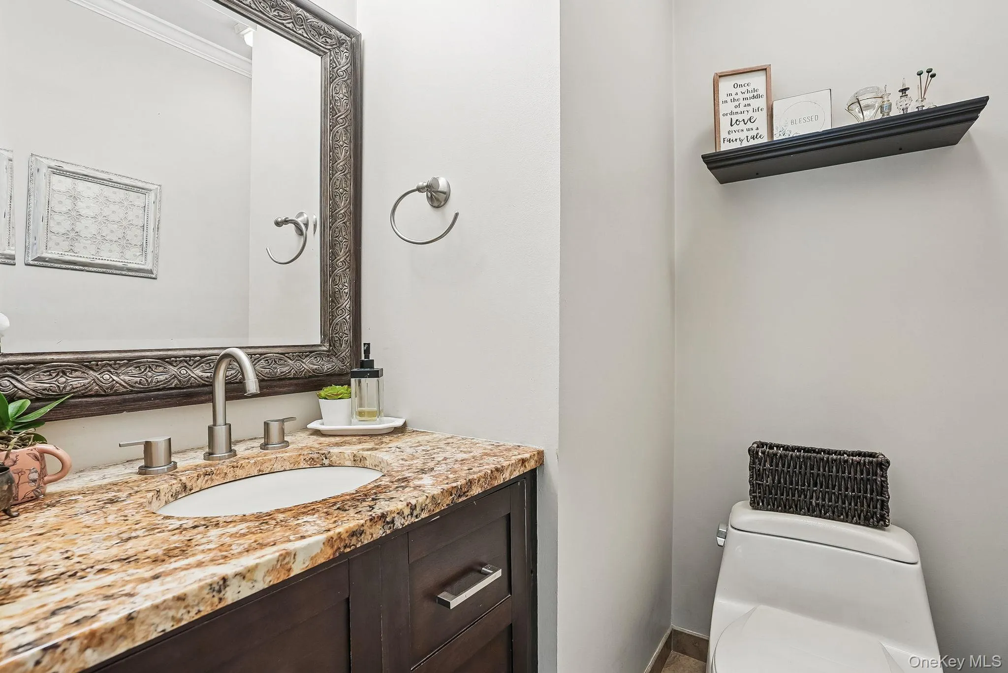 Half bath with toilet, vanity, and crown molding Half bath with toilet, vanity, and crown molding