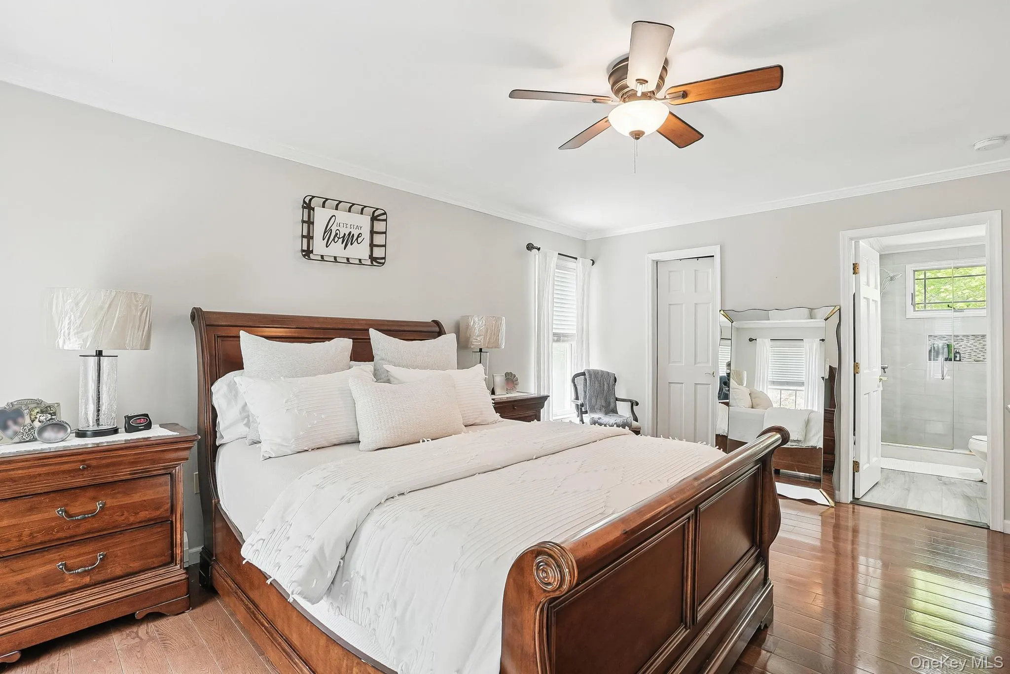 Bedroom with light wood-style flooring, a closet, crown molding, ensuite bath, and ceiling fan Bedroom with light wood-style flooring, a closet, crown molding, ensuite bath, and ceiling fan