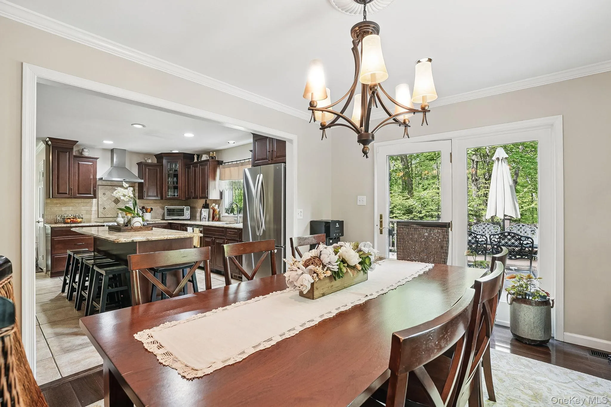 Dining area with a chandelier, crown molding, and recessed lighting Dining area with a chandelier, crown molding, and recessed lighting