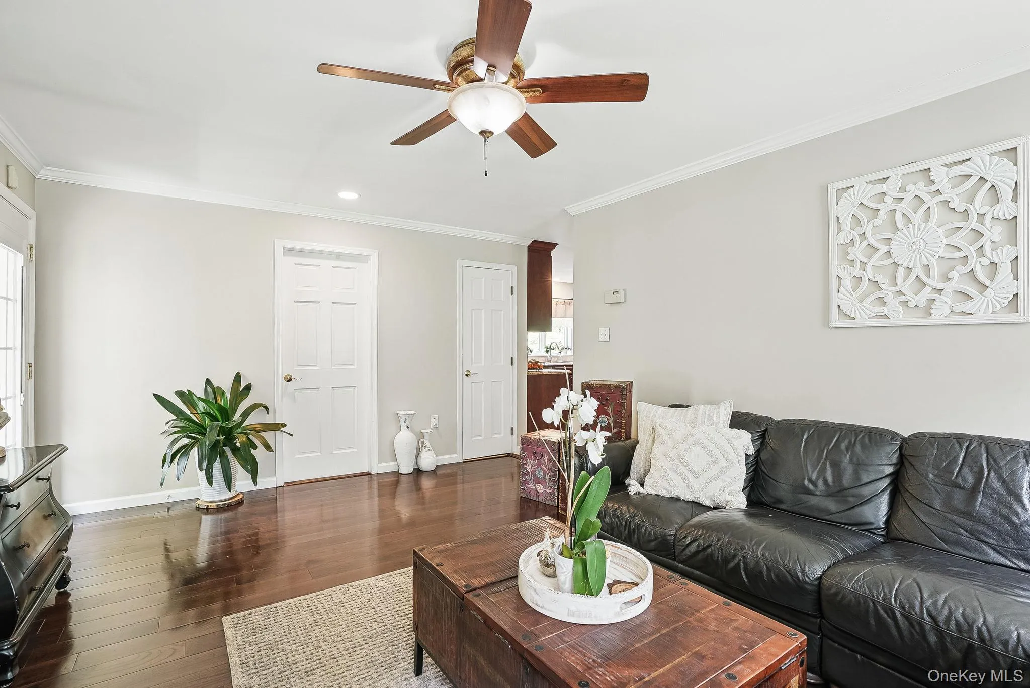 Living room featuring a ceiling fan, dark wood finished floors, crown molding, baseboards, and recessed lighting Living room featuring a ceiling fan, dark wood finished floors, crown molding, baseboards, and recessed lighting