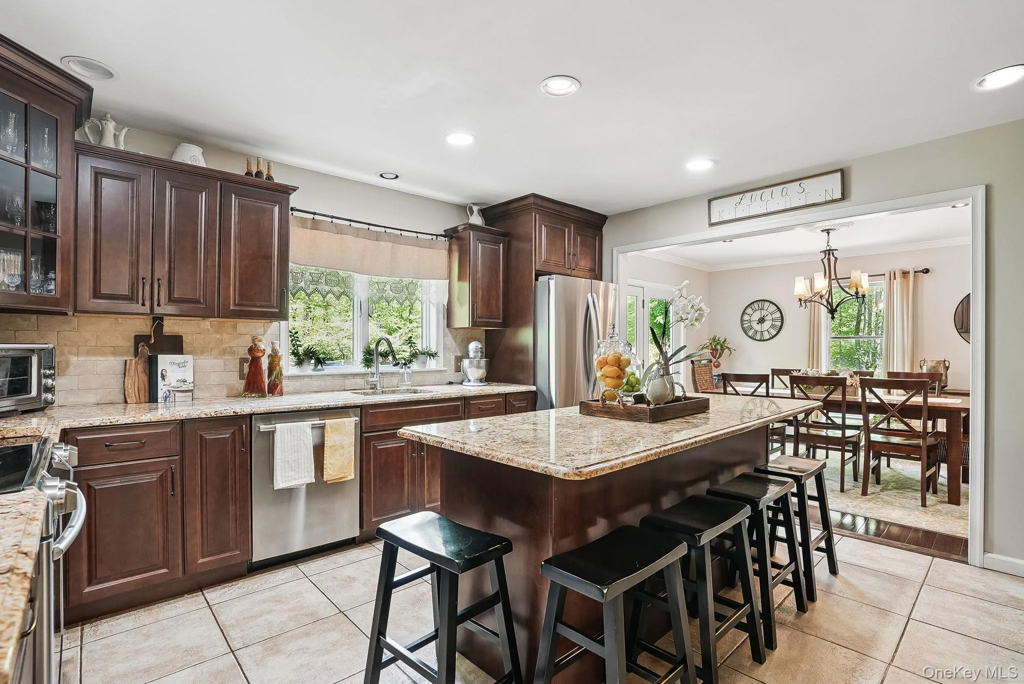 Kitchen featuring stainless steel appliances, a sink, light tile patterned flooring, tasteful backsplash, and recessed lighting Kitchen featuring stainless steel appliances, a sink, light tile patterned flooring, tasteful backsplash, and recessed lighting