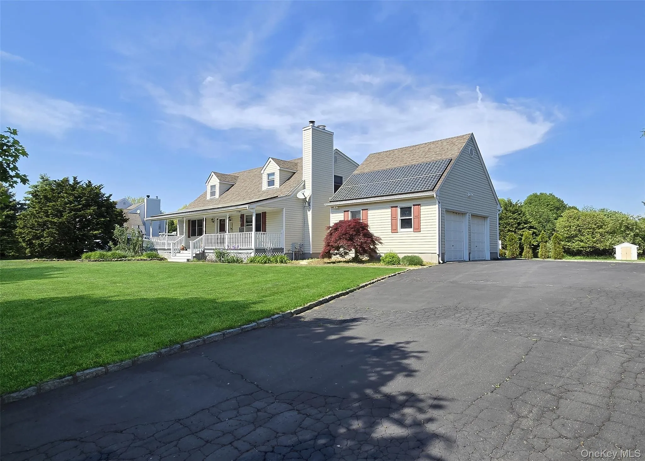 Front of home/Solar Panels with a 2 car garage, spacious driveway Front of home/Solar Panels with a 2 car garage, spacious driveway