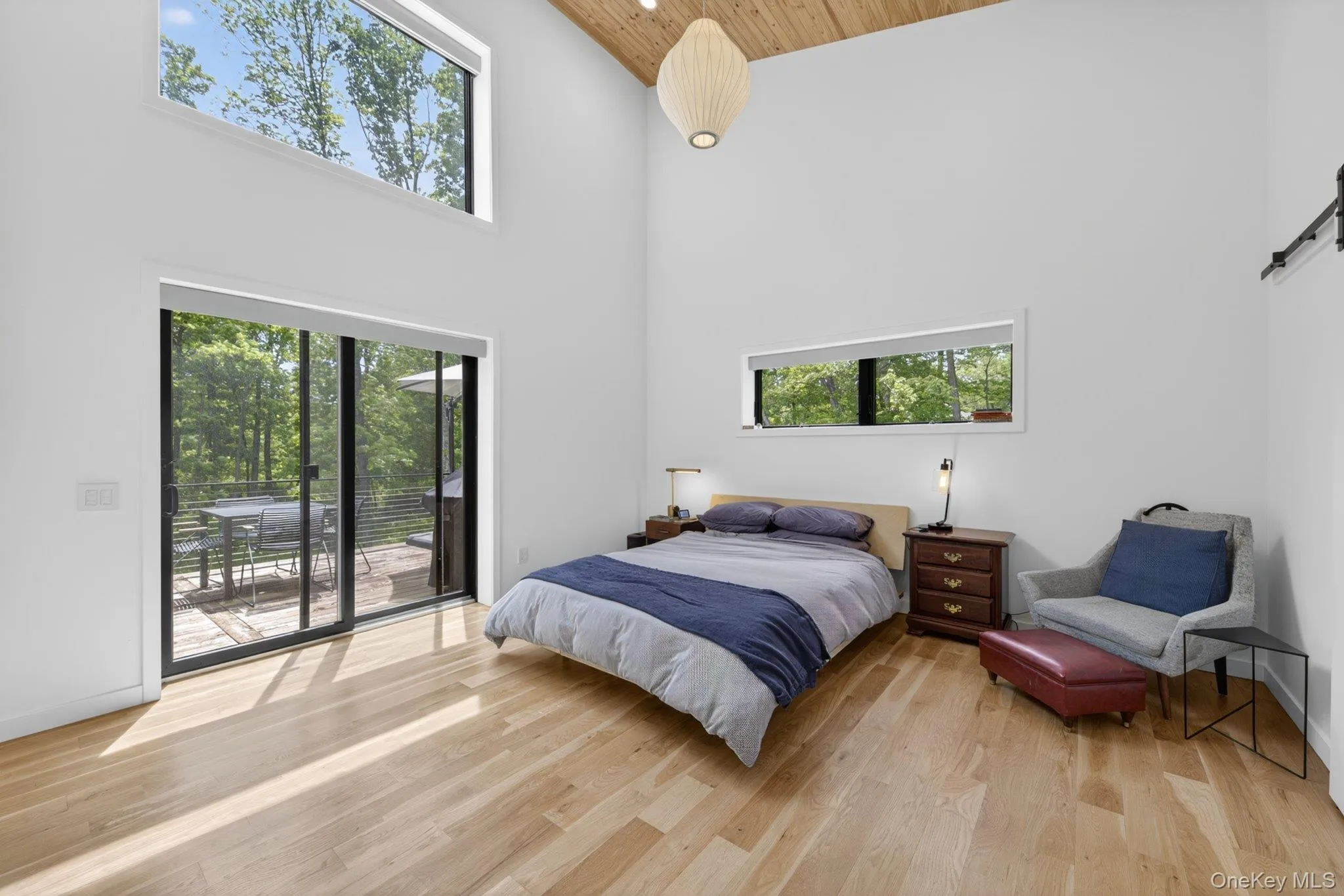 The primary bedroom featuring a vaulted wood-paneled ceiling The primary bedroom featuring a vaulted wood-paneled ceiling