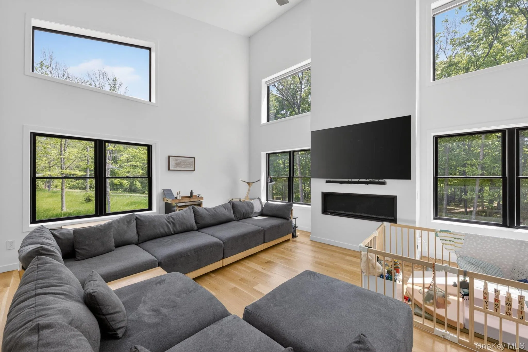 The double-height ceilings and contemporary fireplace create a dramatic space The double-height ceilings and contemporary fireplace create a dramatic space