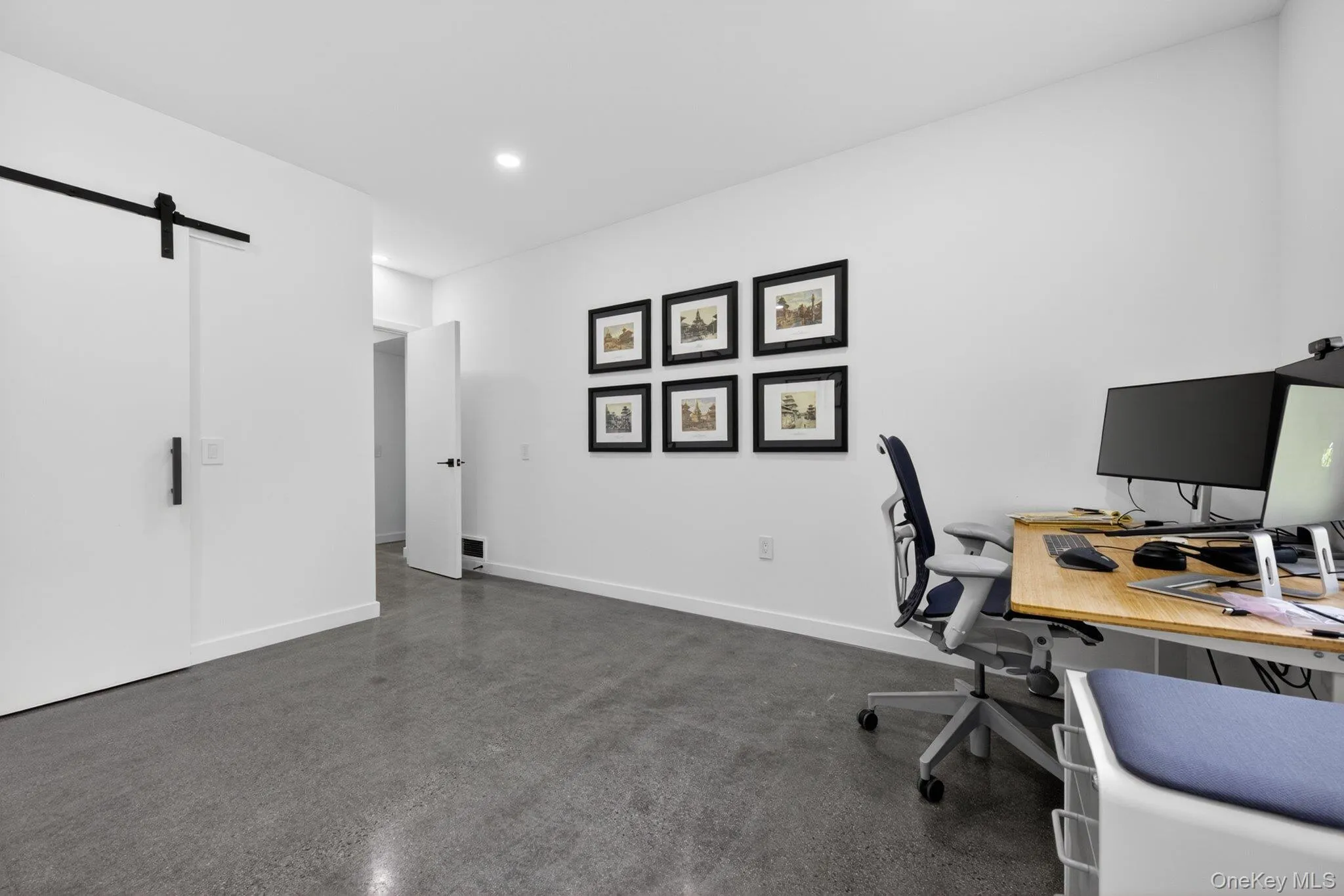 Recessed lighting and white walls create a bright workspace Recessed lighting and white walls create a bright workspace