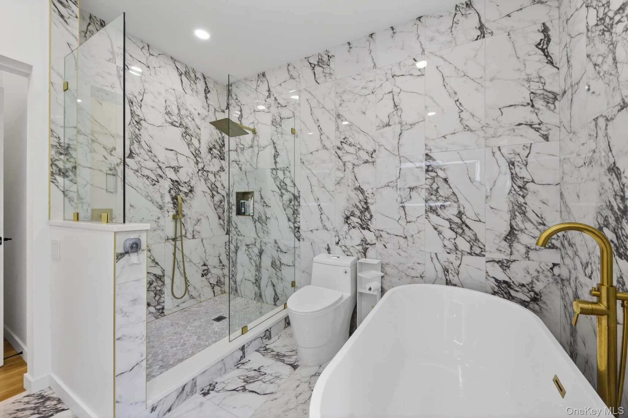 A frameless glass shower enclosure with a rain shower head A frameless glass shower enclosure with a rain shower head