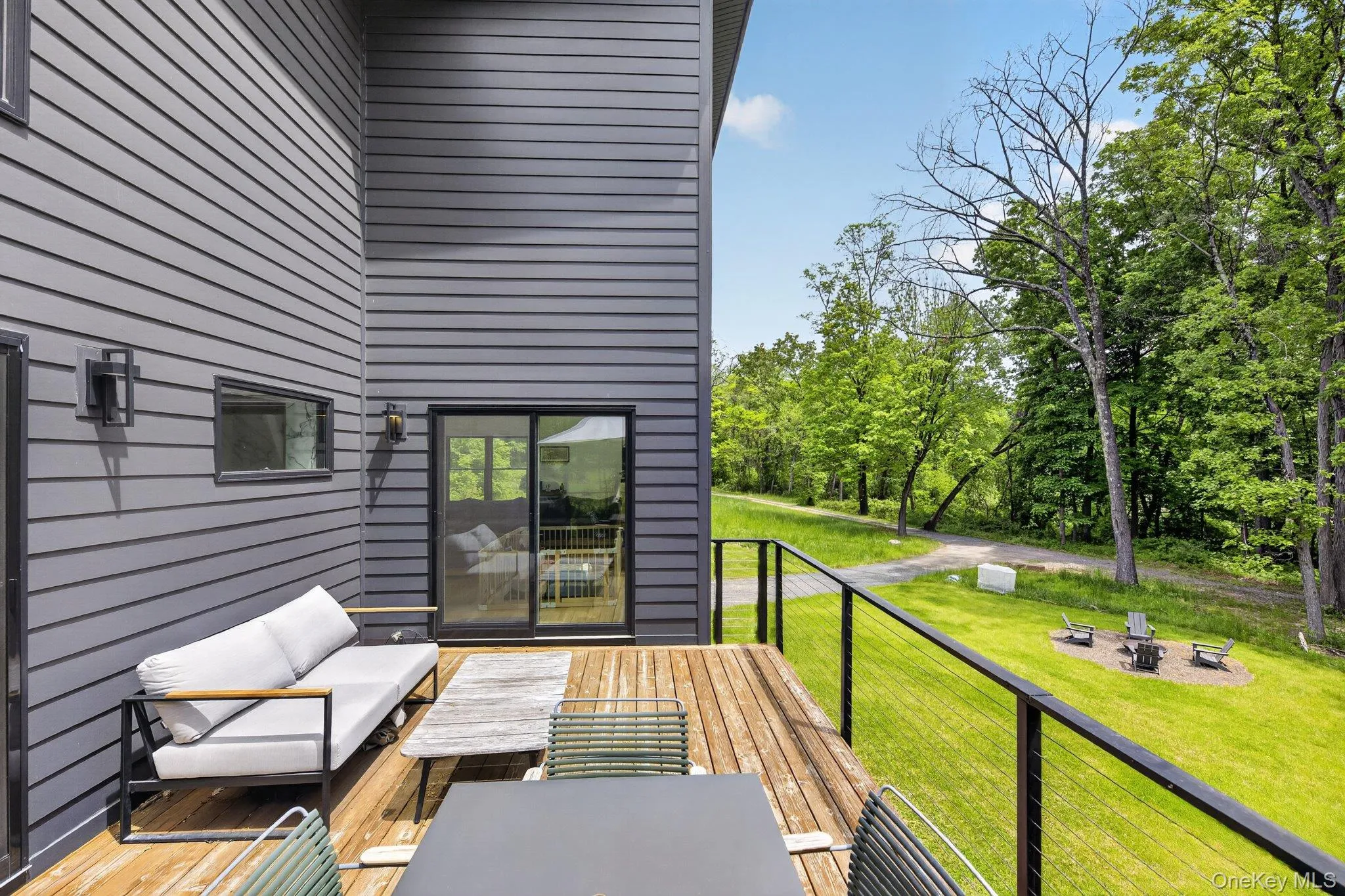 Expansive wood-finish deck with cable railing Expansive wood-finish deck with cable railing