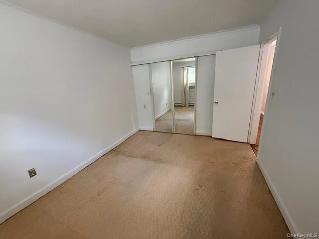 Second bedroom with large mirrored closet.Carpet in process of being replaced.. Second bedroom with large mirrored closet.Carpet in process of being replaced..