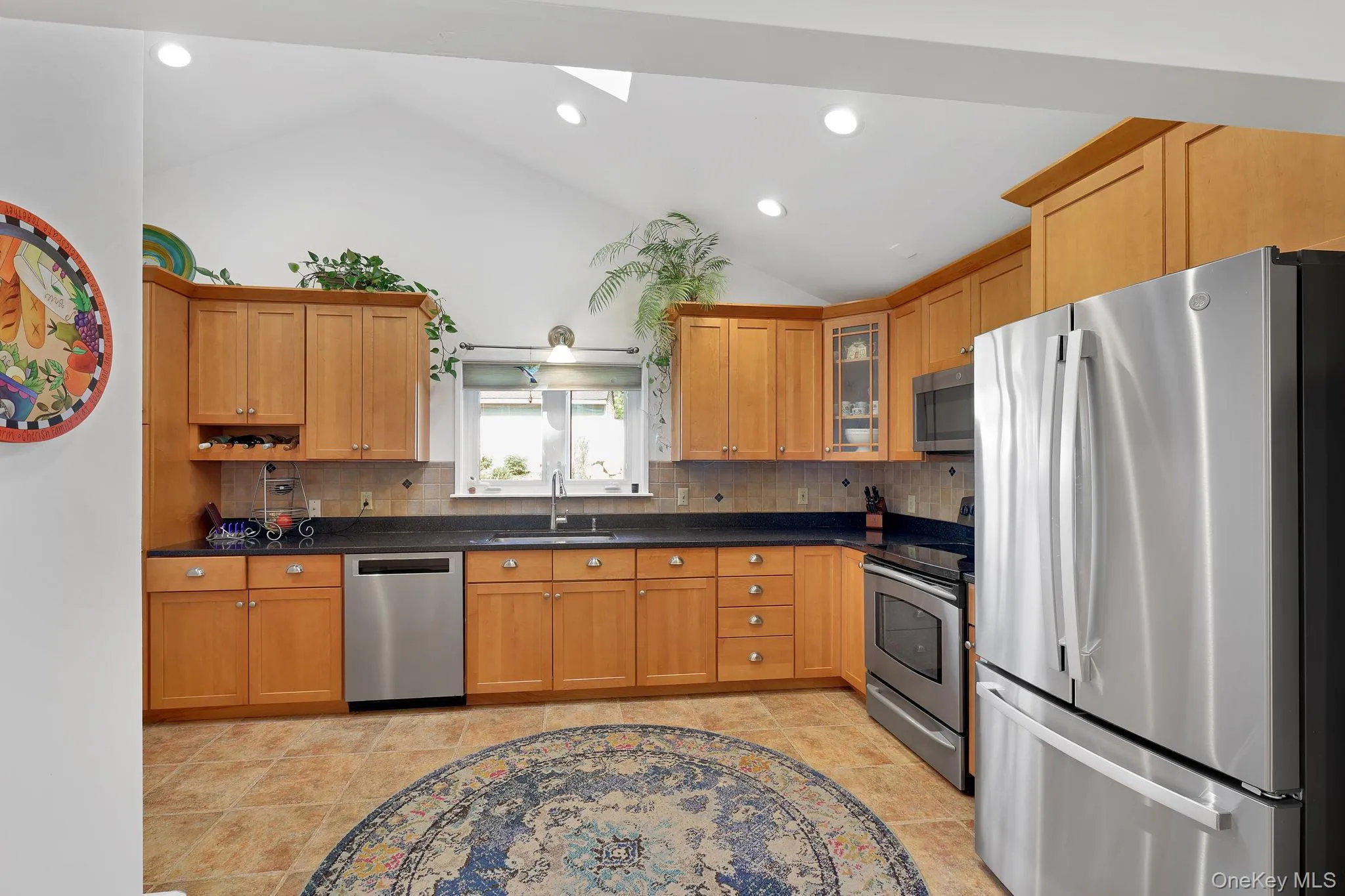 Kitchen with wooden tile tongue and groove flooring. Stainless Steel Appliances and skylight. Kitchen with wooden tile tongue and groove flooring. Stainless Steel Appliances and skylight.