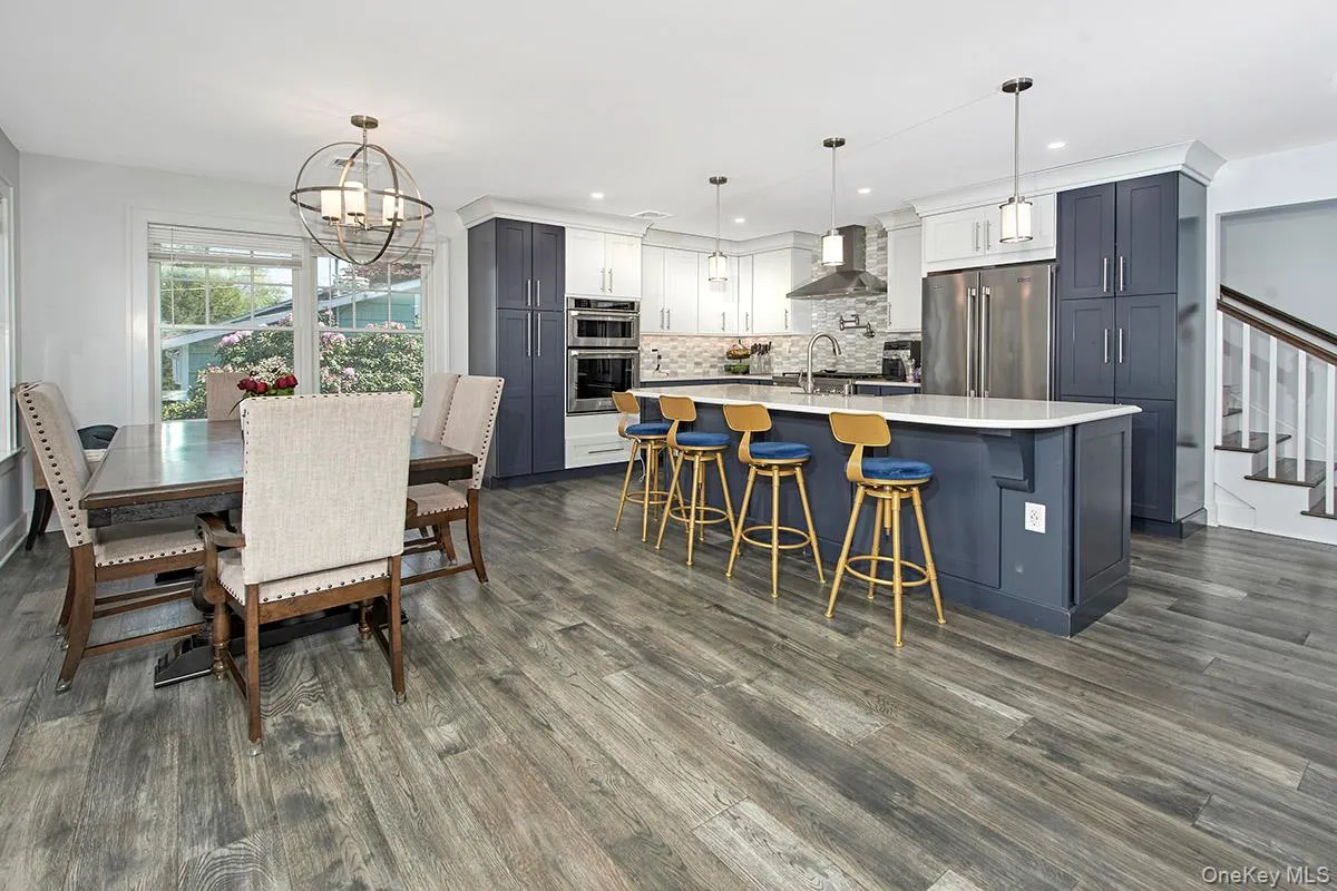Open-concept kitchen and dining area featuring wood-finish flooring Open-concept kitchen and dining area featuring wood-finish flooring