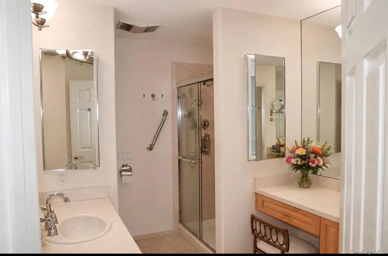 Bathroom vanity featuring an integrated sink, polished chrome faucet, and mirrored medicine cabinet Bathroom vanity featuring an integrated sink, polished chrome faucet, and mirrored medicine cabinet