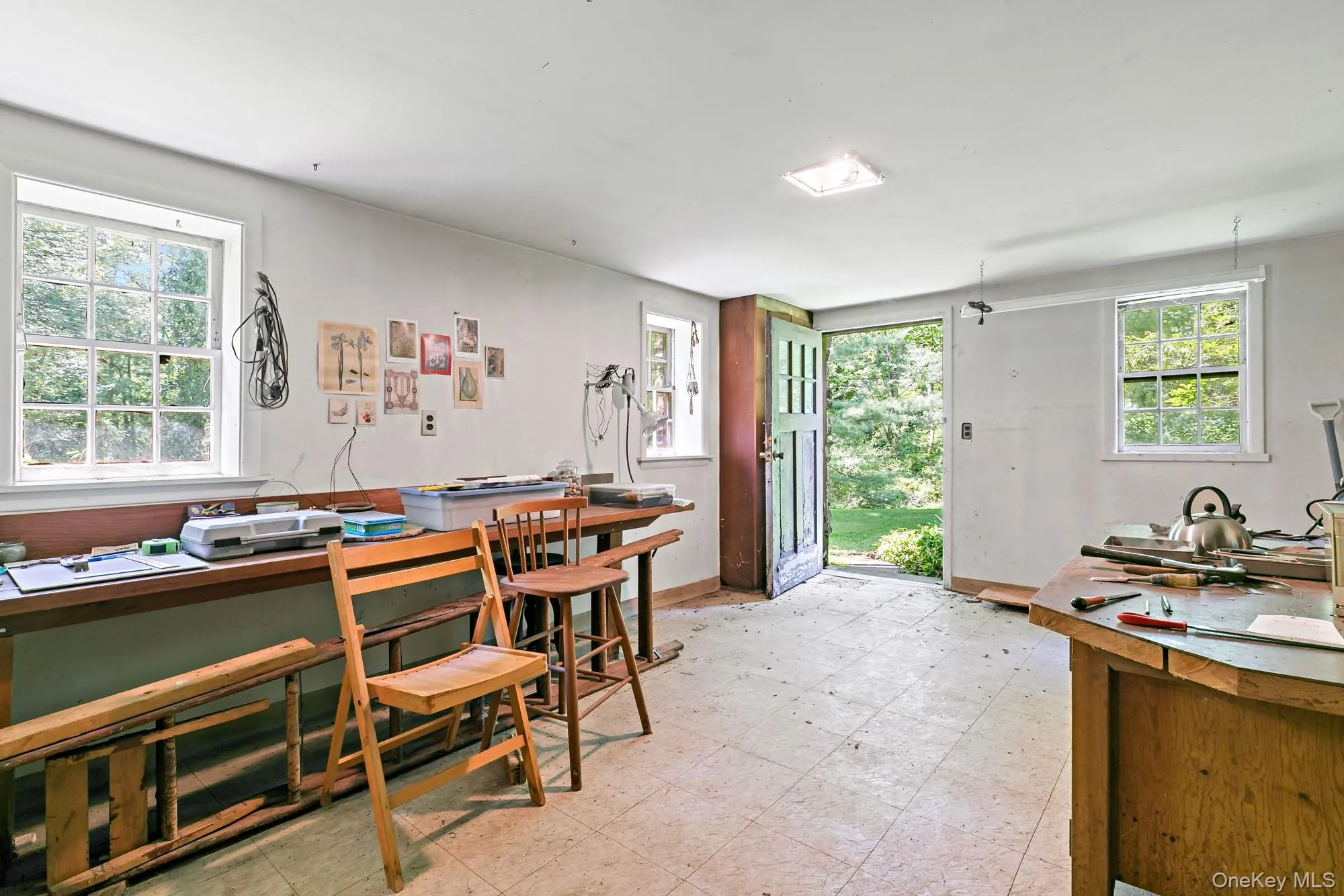 Lower level art studio with door out. Lower level art studio with door out.