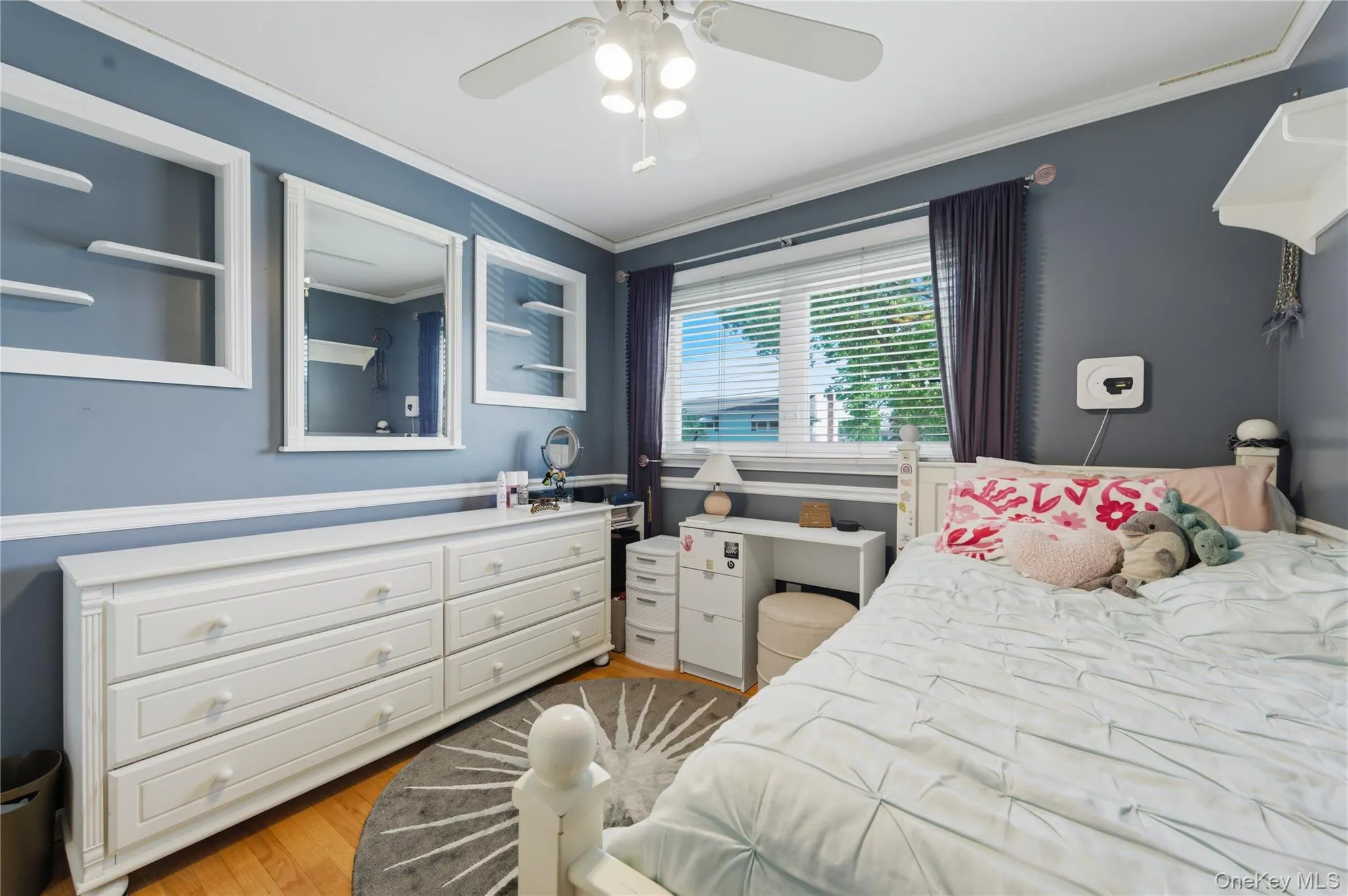 Bed Room 2 featuring wood-finish flooring, a ceiling fan with integrated lighting, and a window with blinds Bed Room 2 featuring wood-finish flooring, a ceiling fan with integrated lighting, and a window with blinds