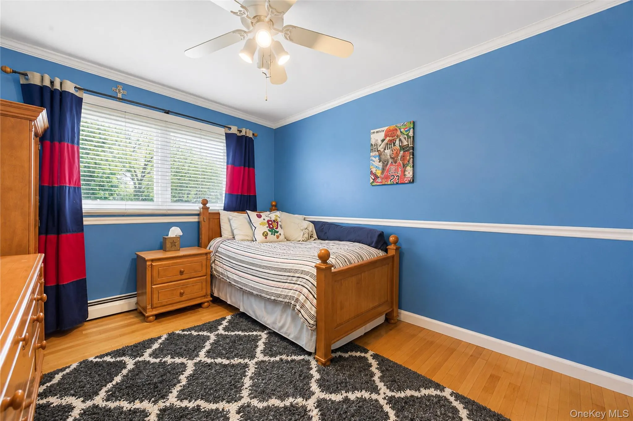 Bedroom 1 featuring a ceiling fan with integrated lighting, crown molding, and wood-finish flooring Bedroom 1 featuring a ceiling fan with integrated lighting, crown molding, and wood-finish flooring