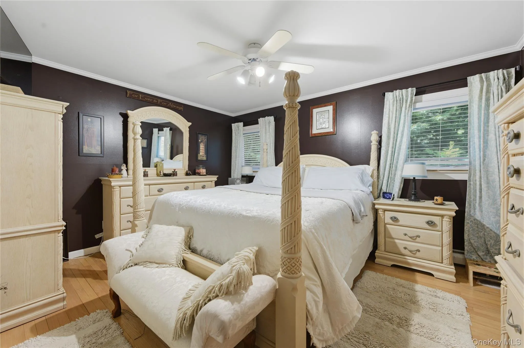 Primary Bedroom w/Hardwood-finish flooring complementing dark walls with white trim Primary Bedroom w/Hardwood-finish flooring complementing dark walls with white trim