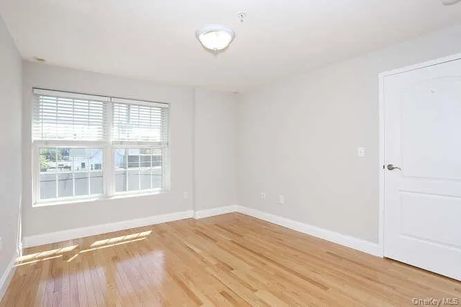 Empty room with light wood-style flooring and baseboards Empty room with light wood-style flooring and baseboards
