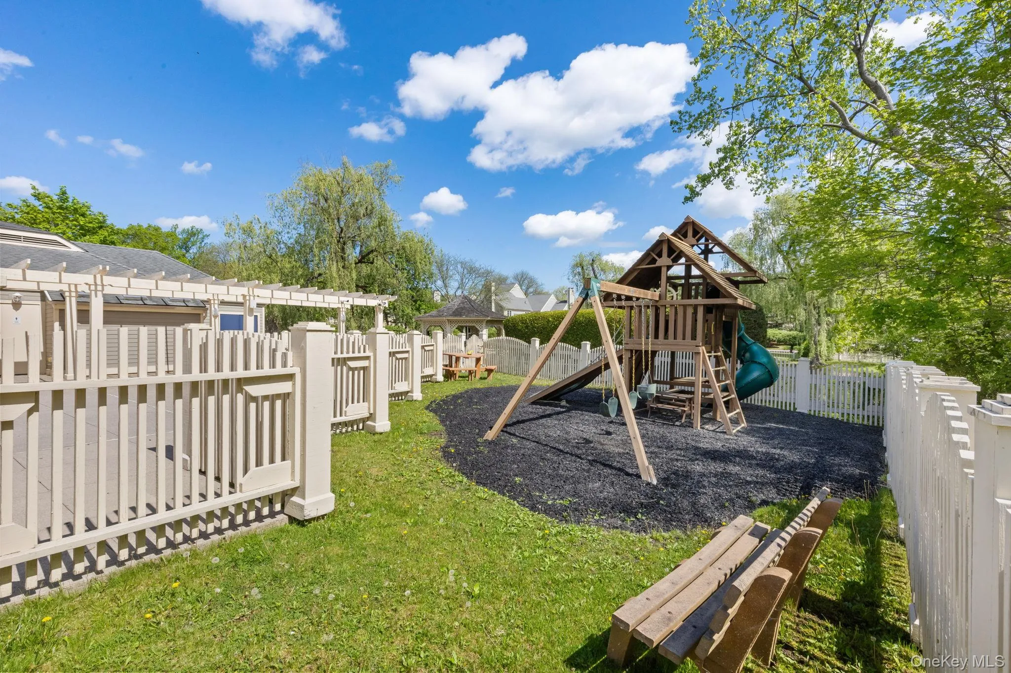 View of playground featuring a pergola View of playground featuring a pergola