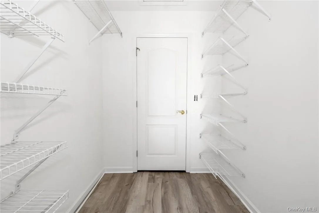 Walk in closet in primary bedroom. Walk in closet in primary bedroom.
