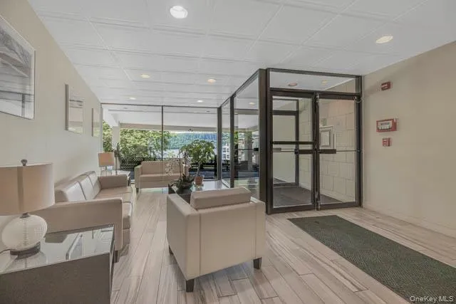 Spacious communal lobby featuring wood-finish flooring, recessed lighting, and expansive glass walls Spacious communal lobby featuring wood-finish flooring, recessed lighting, and expansive glass walls
