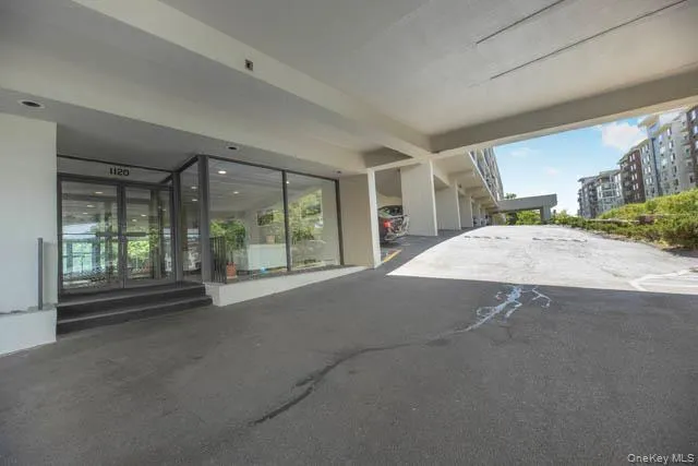 Building entrance featuring large glass panels, a double-door entry, and an integrated address number Building entrance featuring large glass panels, a double-door entry, and an integrated address number