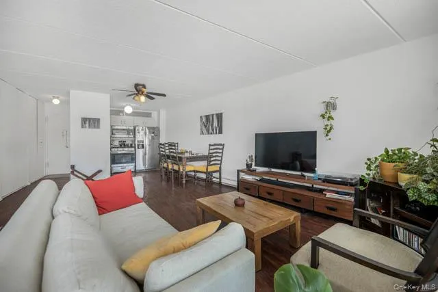 Open-concept living space featuring wood-finish flooring, recessed lighting, and a ceiling fan Open-concept living space featuring wood-finish flooring, recessed lighting, and a ceiling fan