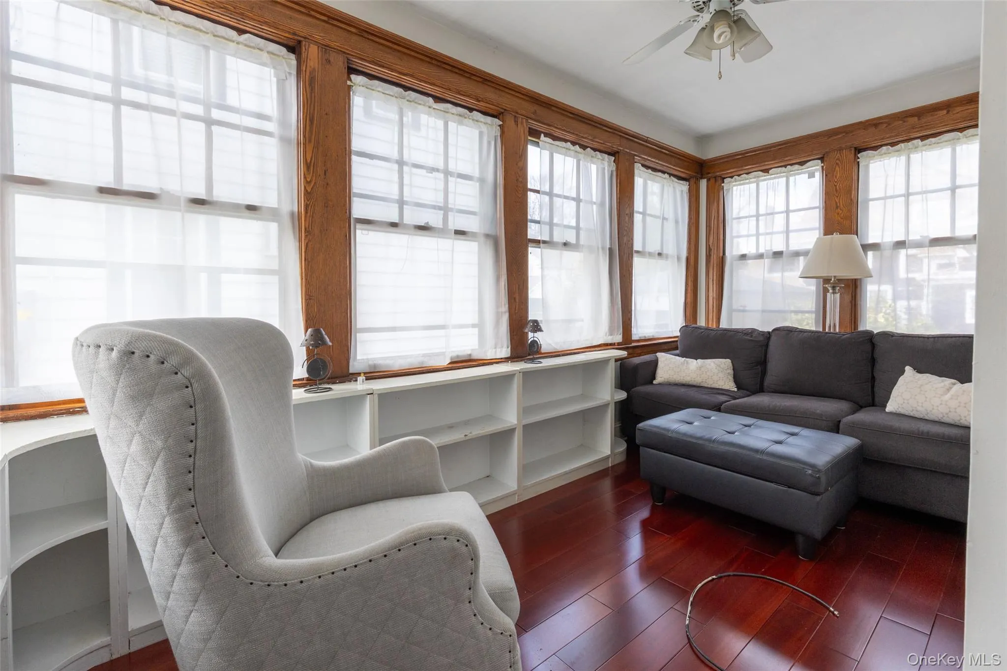 Wood-finish flooring with extensive window coverage featuring natural wood trim Wood-finish flooring with extensive window coverage featuring natural wood trim