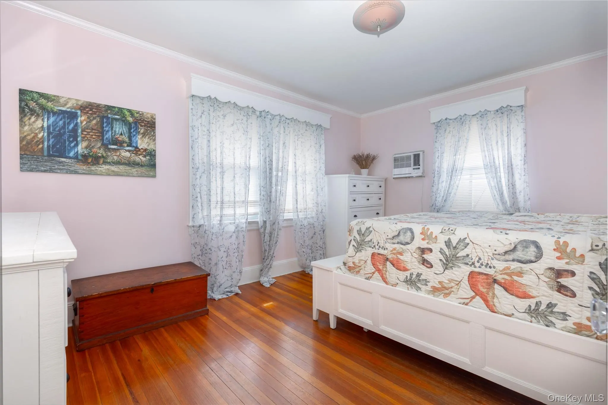 Hardwood flooring throughout, complemented by light-colored walls and white trim Hardwood flooring throughout, complemented by light-colored walls and white trim