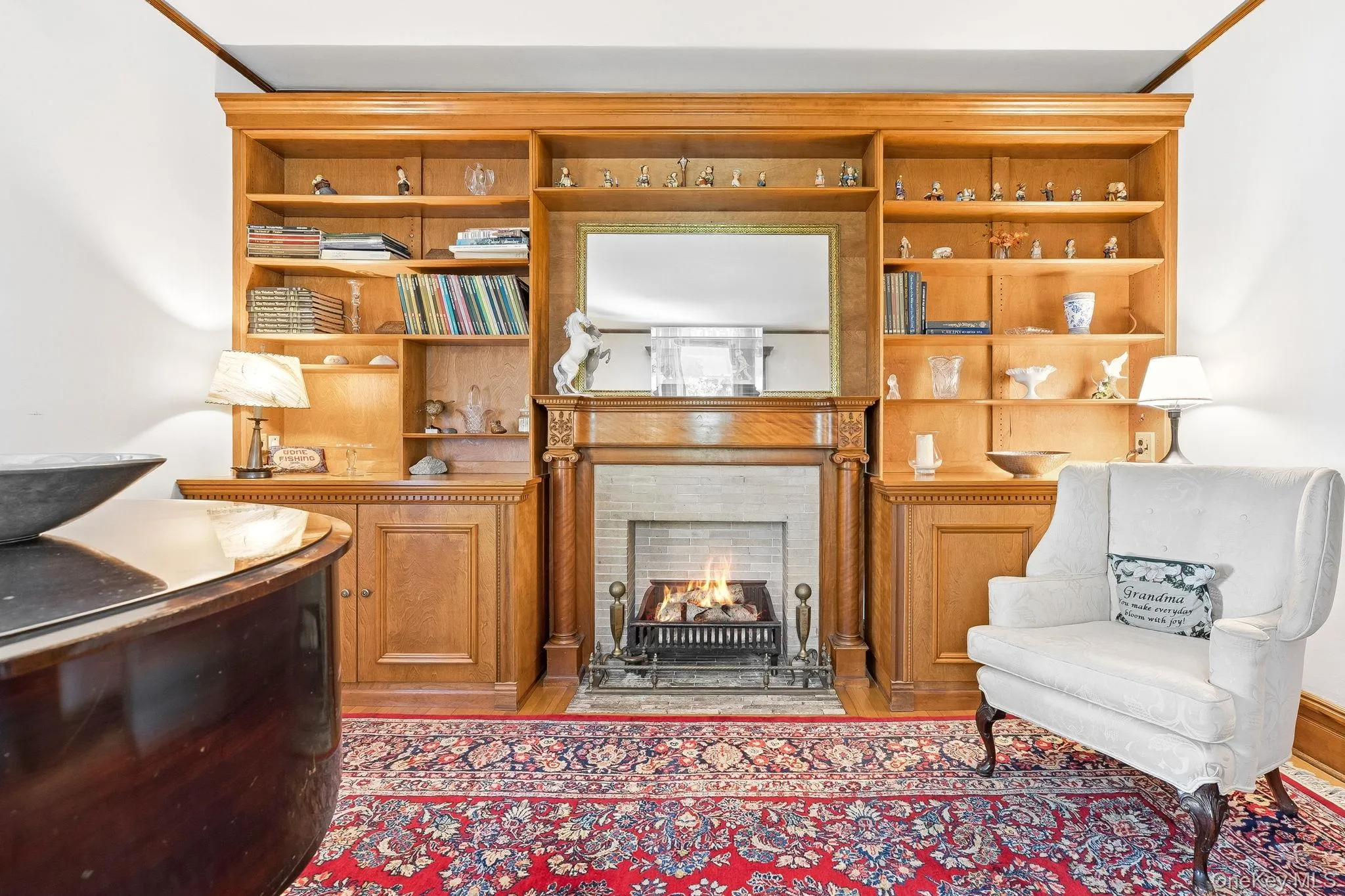 Built-in bookcases and a grand piano create a space rich in culture and charm. The fireplace is decorative only. Built-in bookcases and a grand piano create a space rich in culture and charm. The fireplace is decorative only.