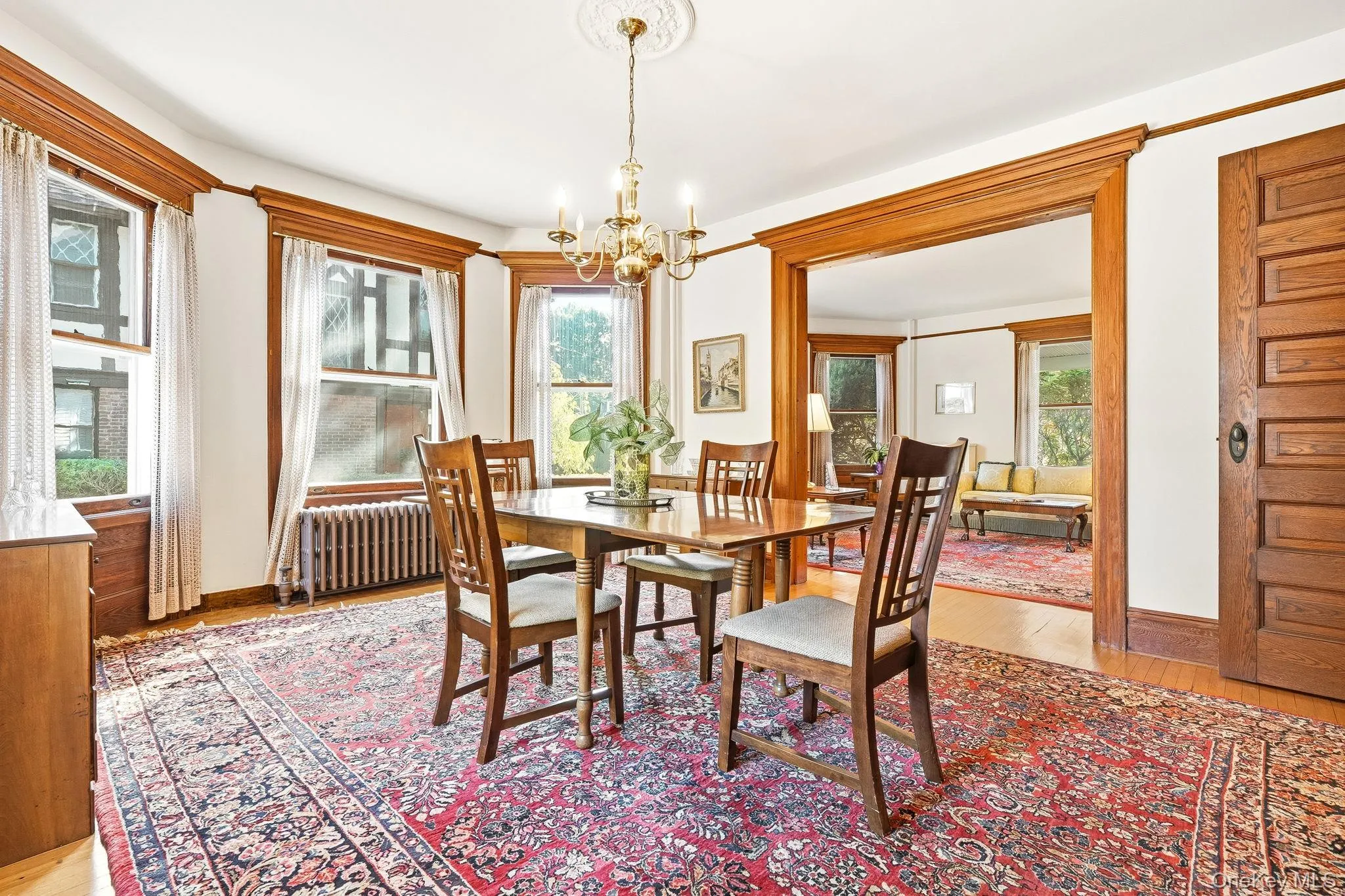 An elegant formal dining room illuminated by a striking chandelier. An elegant formal dining room illuminated by a striking chandelier.