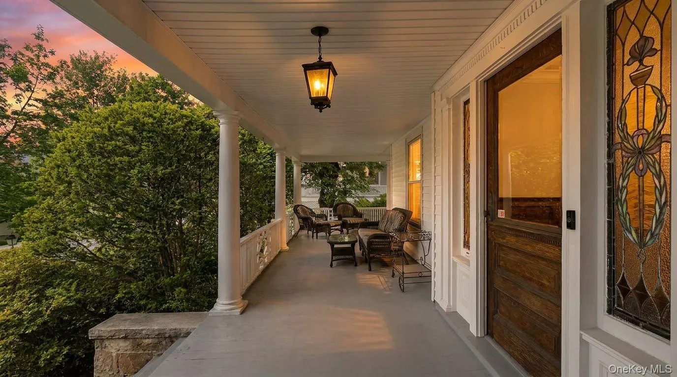 The wraparound porch glows beautifully as day turns to evening. The wraparound porch glows beautifully as day turns to evening.