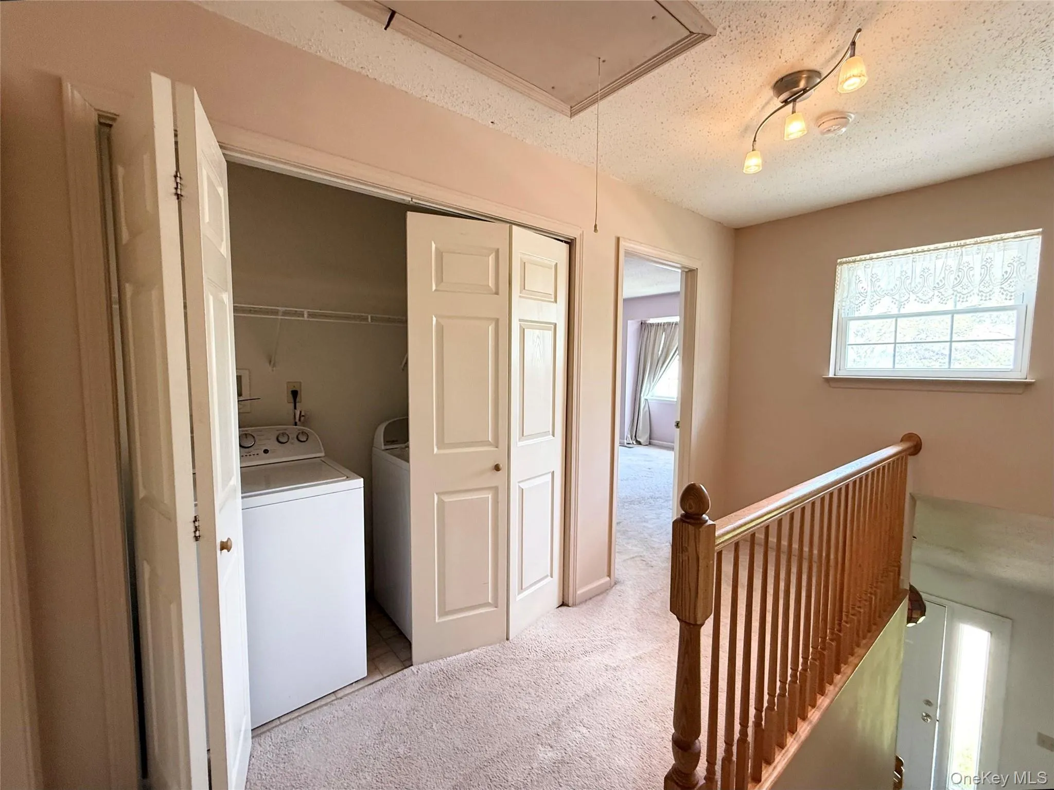 Convenient second floor laundry area. Notice the pull-down staircase for attic storage. Convenient second floor laundry area. Notice the pull-down staircase for attic storage.