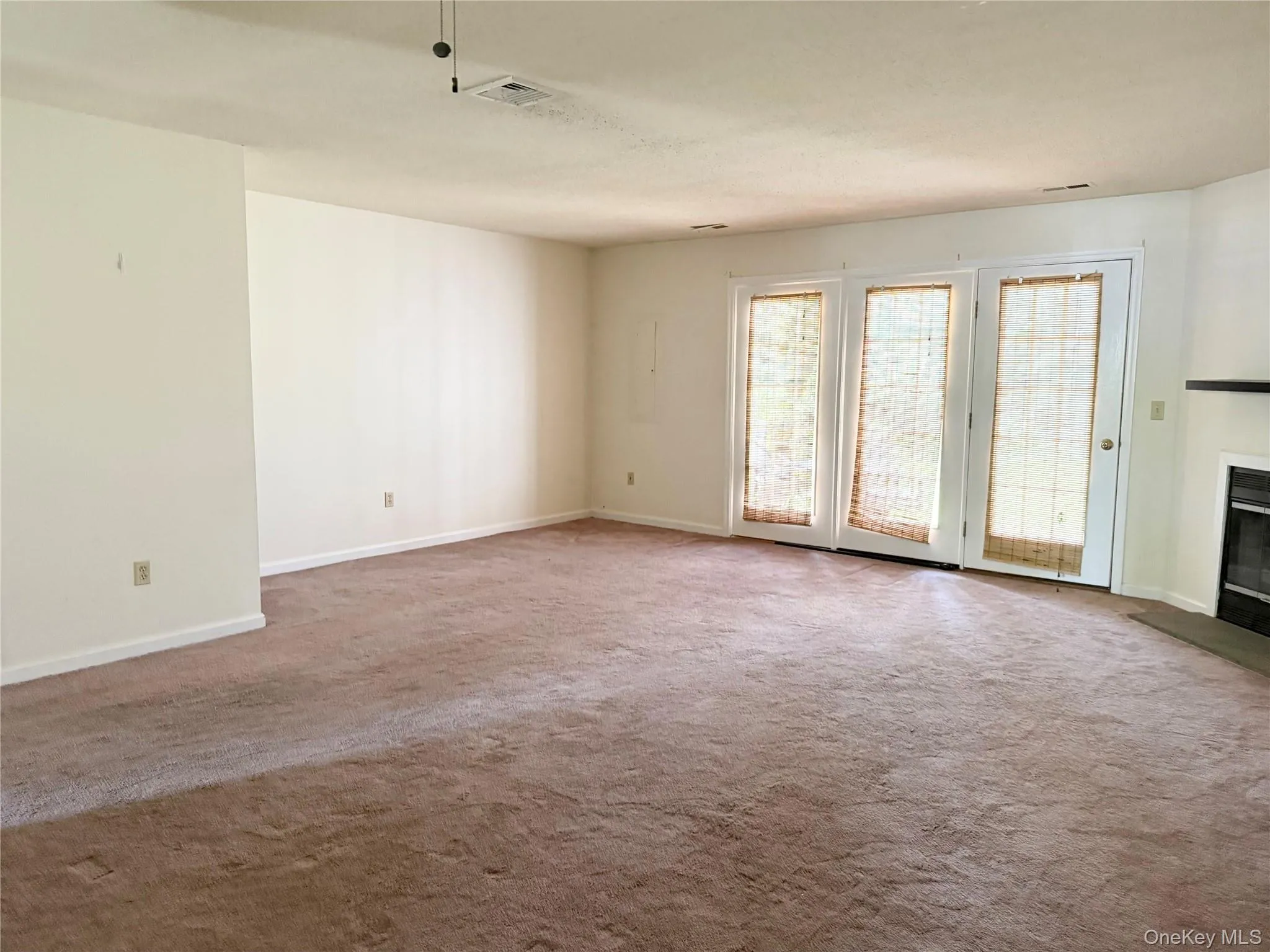Doors leads to a brick patio and personal storage room. Doors leads to a brick patio and personal storage room.