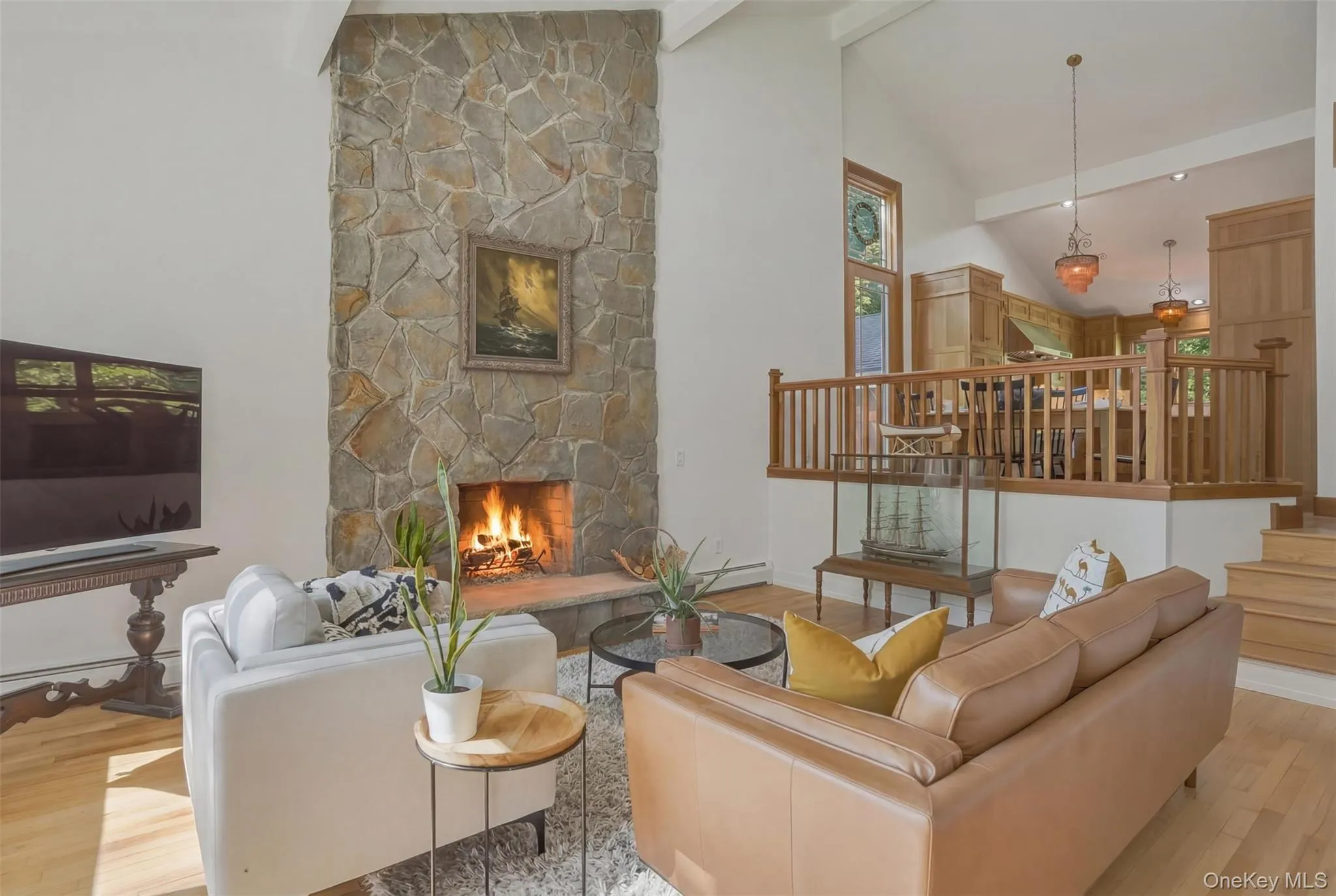 Living Room featuring soaring fireplace in open floor plan living space. Living Room featuring soaring fireplace in open floor plan living space.