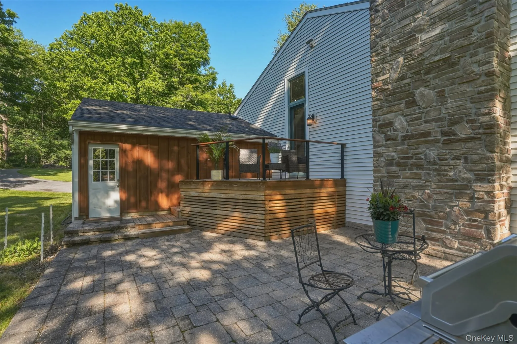 Patio area leading to garage backdoor. Patio area leading to garage backdoor.