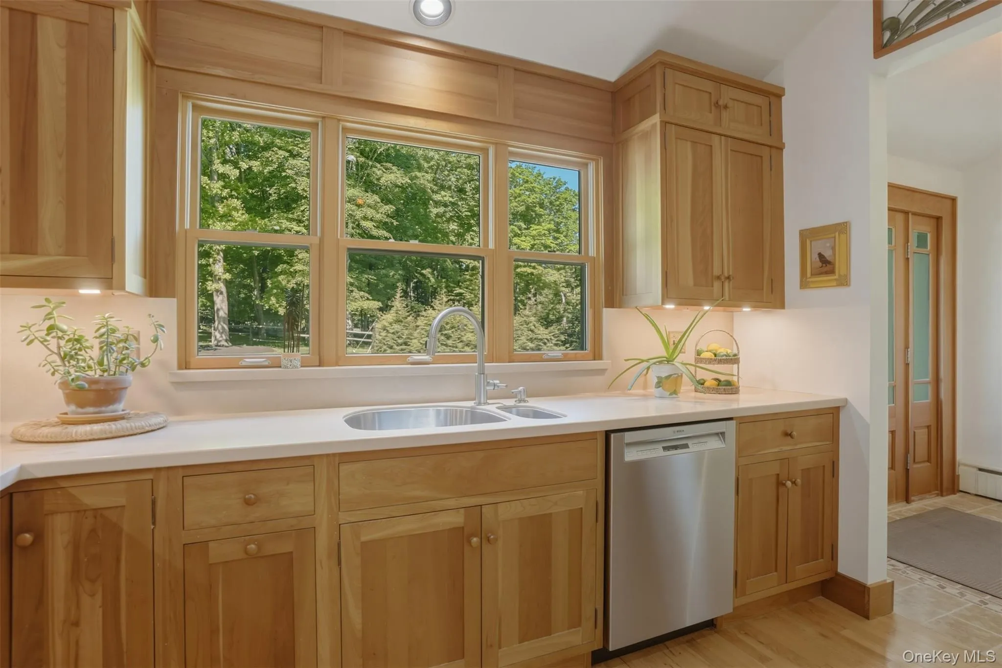 Chef's kitchen featuring dual sink and dishwasher with beautiful property view. Chef's kitchen featuring dual sink and dishwasher with beautiful property view.