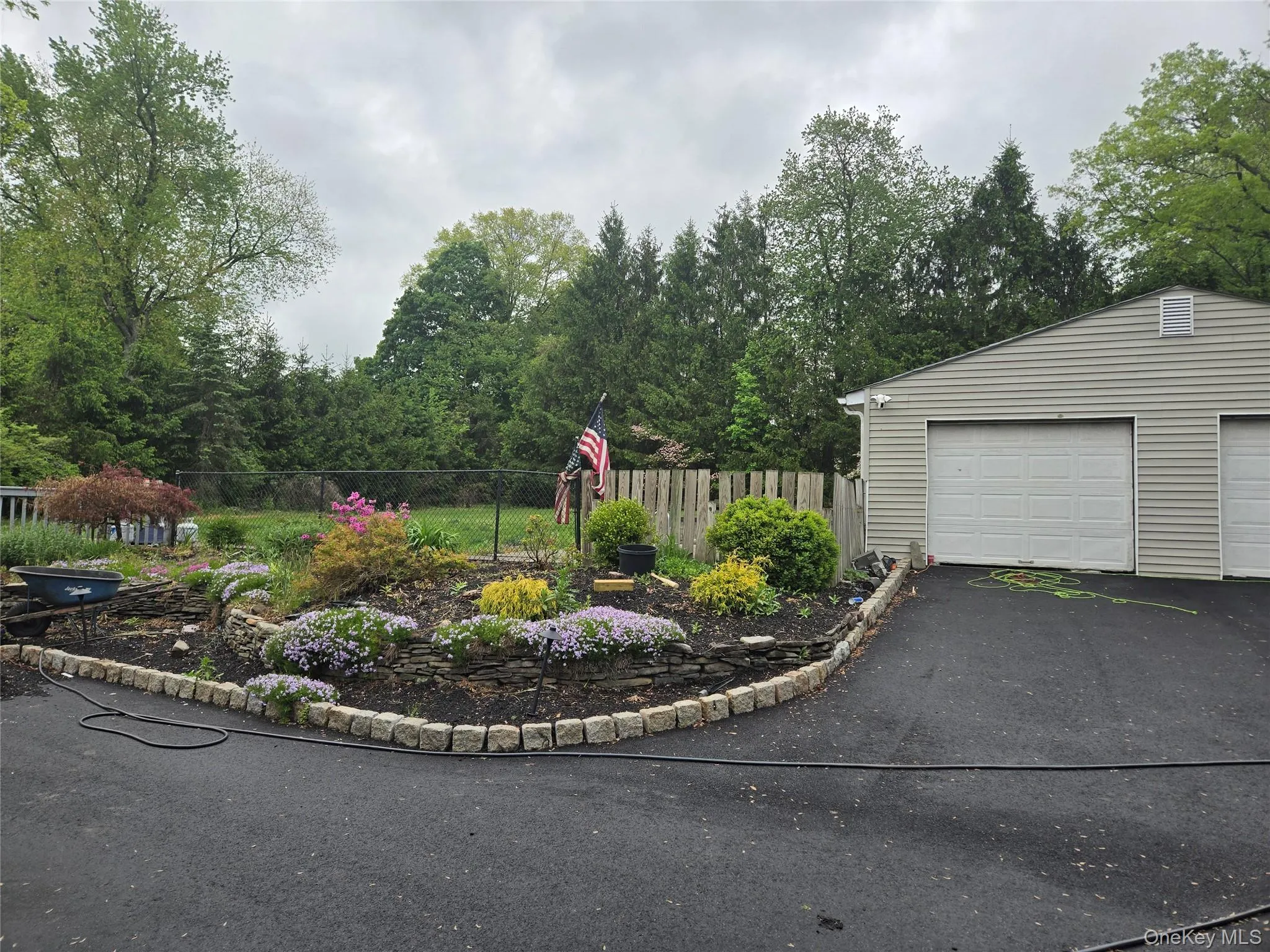 A spacious detached two-car garage provides ample parking, storage, and workspace. The meticulously well maintained grounds create a picturesque setting, offering both beauty and privacy while complementing the home's outstanding features A spacious detached two-car garage provides ample parking, storage, and workspace. The meticulously well maintained grounds create a picturesque setting, offering both beauty and privacy while complementing the home's outstanding features