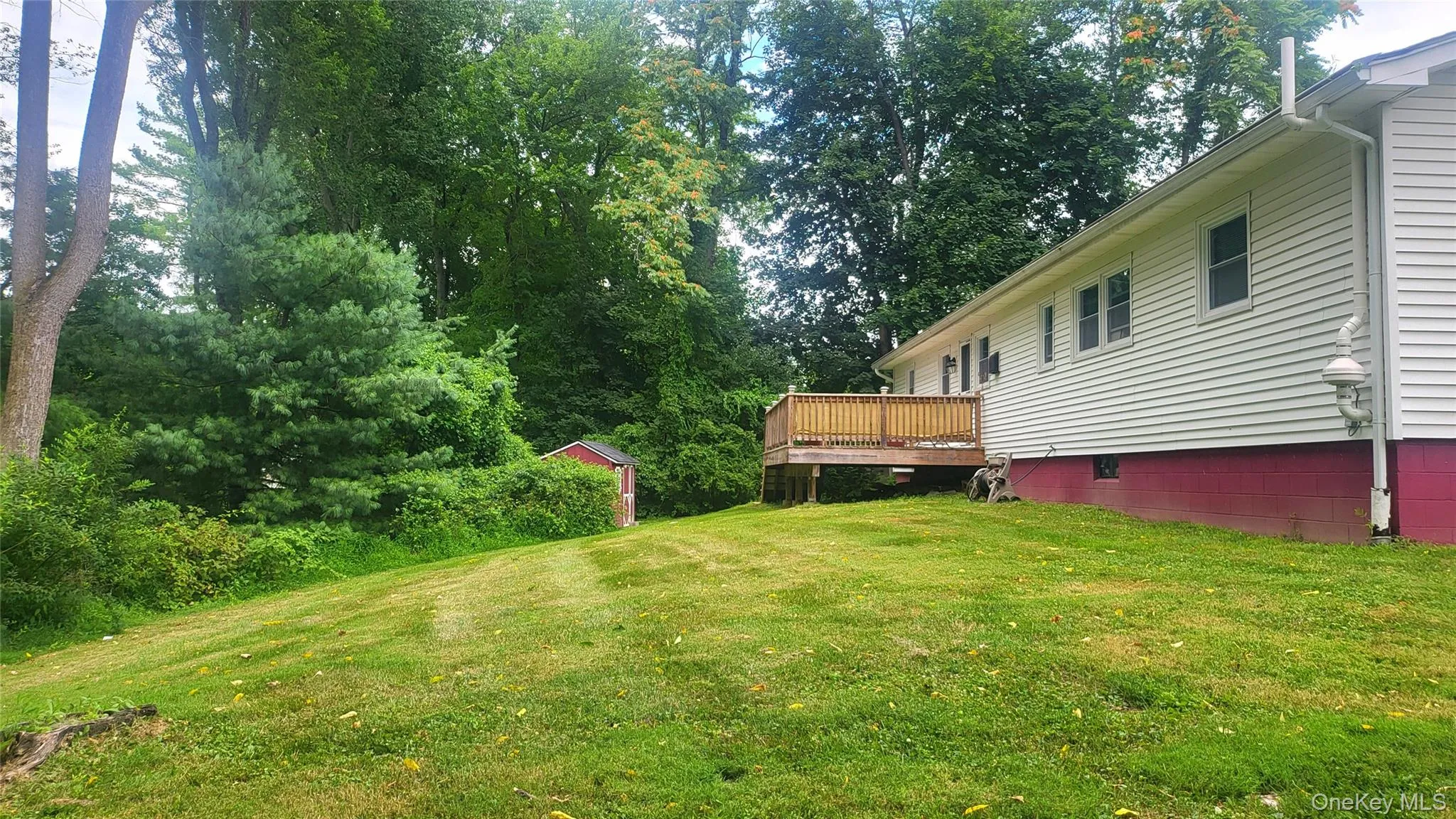 Rear view with a deck and view of lawn Rear view with a deck and view of lawn