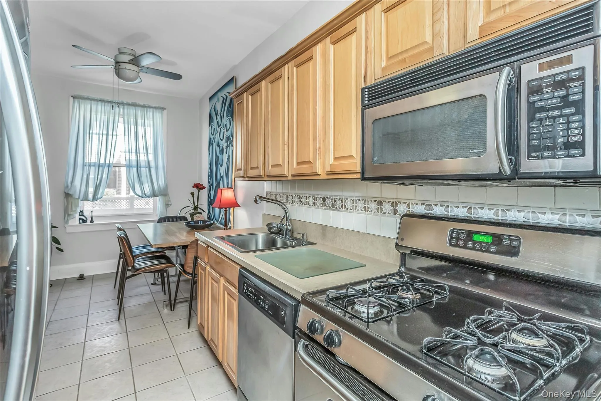 Bright and airy Eat-In Kitchen with light wood cabinets and walkthrough access to the living room and hallway Bright and airy Eat-In Kitchen with light wood cabinets and walkthrough access to the living room and hallway