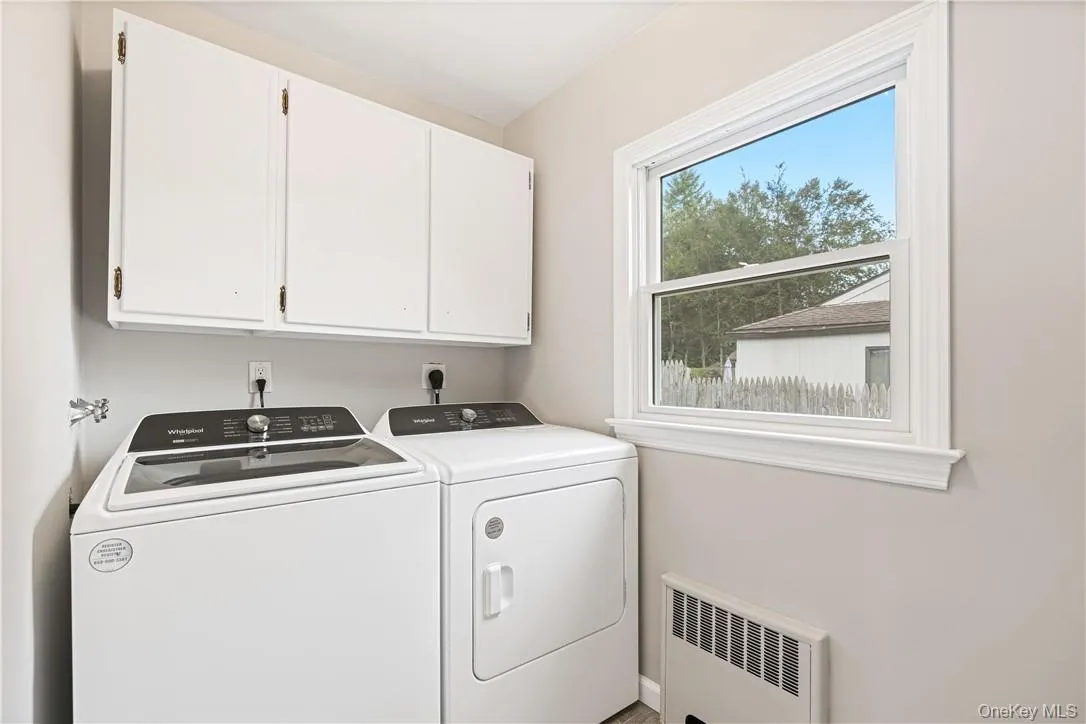 Laundry room with cabinets, and washer and dryer Laundry room with cabinets, and washer and dryer