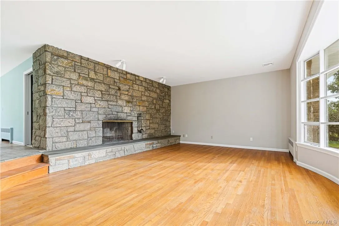 Living room featuring original stone fireplace Living room featuring original stone fireplace