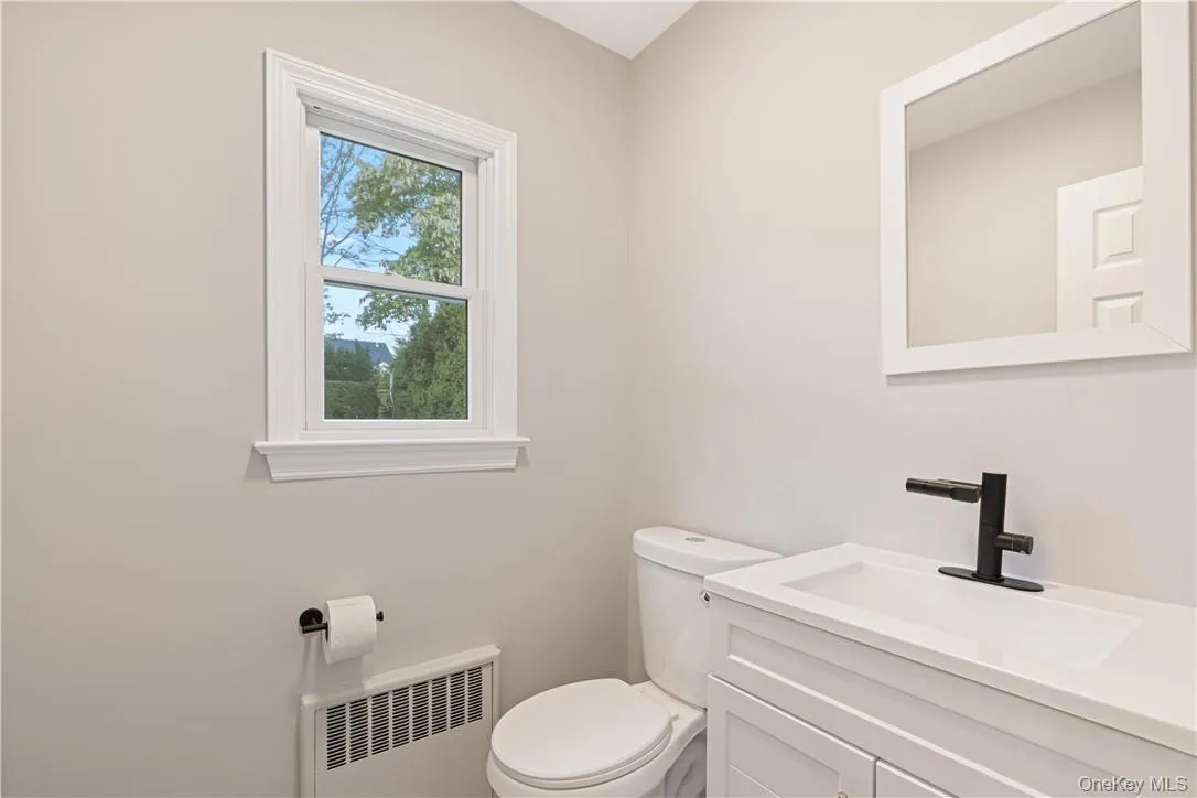 Bathroom featuring vanity with toilet and temperature controlled faucet Bathroom featuring vanity with toilet and temperature controlled faucet