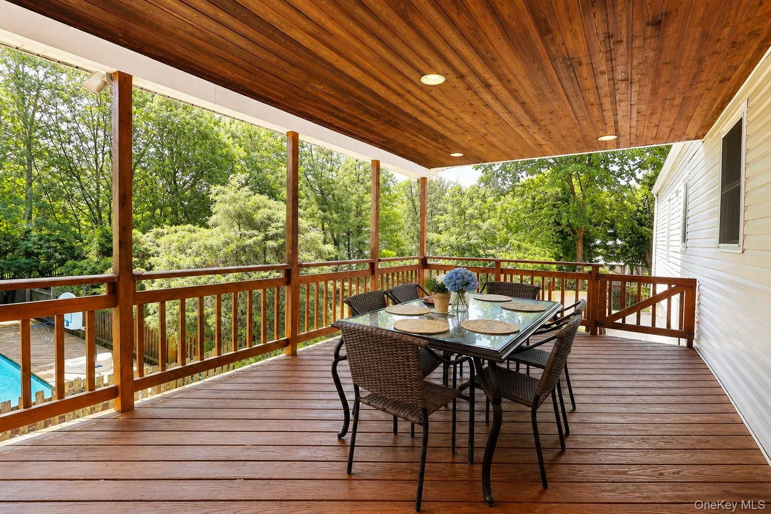 Covered Deck with views overlooking the inground pool Covered Deck with views overlooking the inground pool