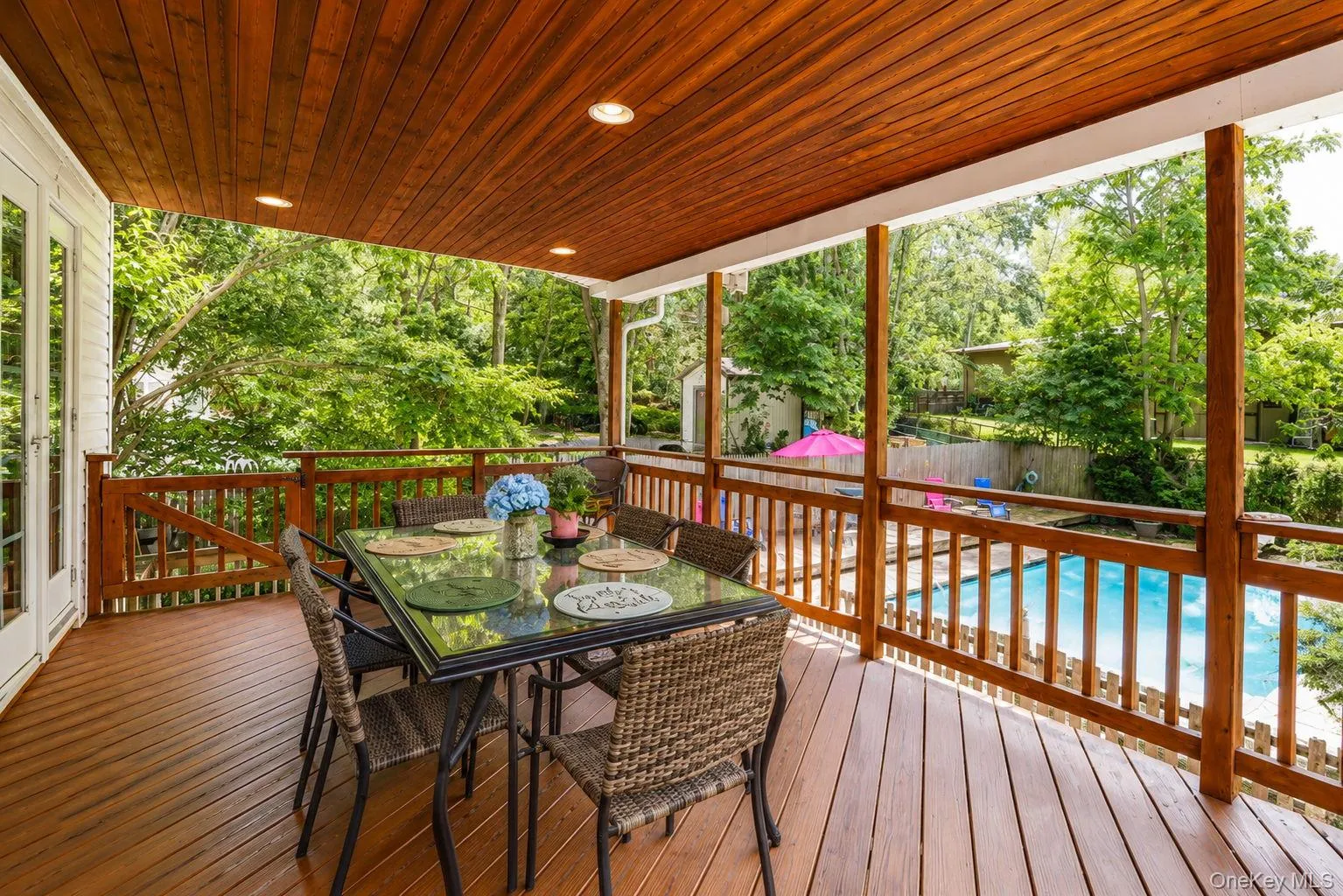 Covered Deck with views overlooking the inground pool Covered Deck with views overlooking the inground pool